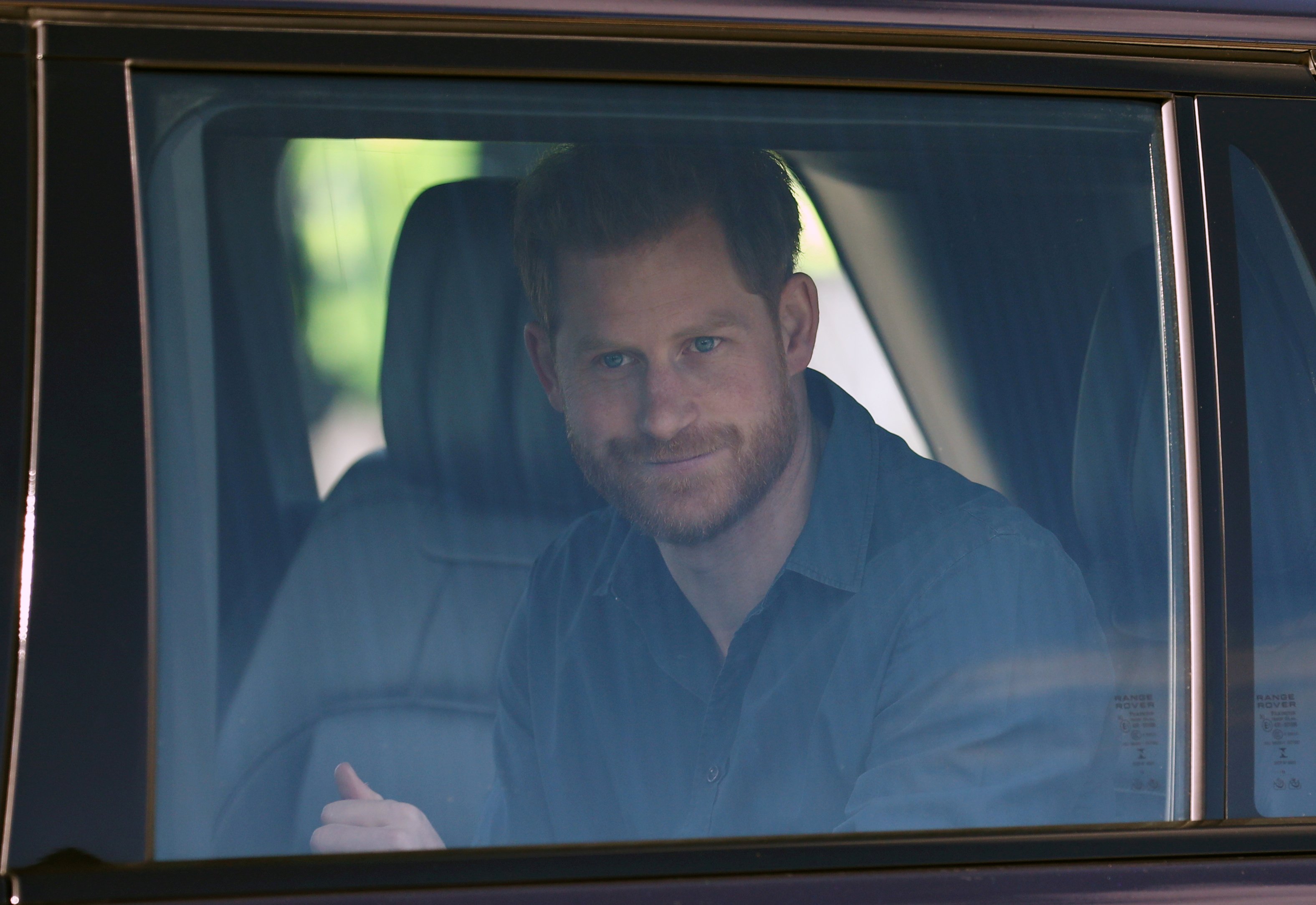 Prince Harry seen through car window for tour to The Silverstone Experience at Silverstone