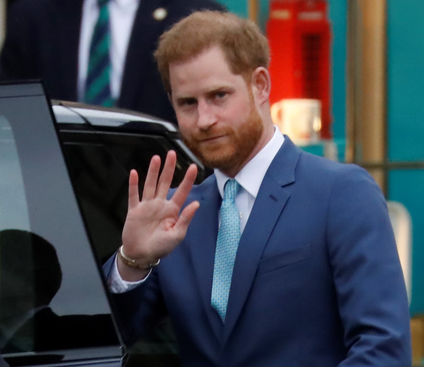 Prince Harry waving goodbye as he leaves the annual Commonwealth Service at Westminster Abbey