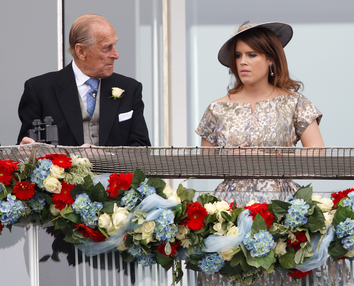 Prince Philip and Princess Eugenie stand at a balcony during Derby Day 2013