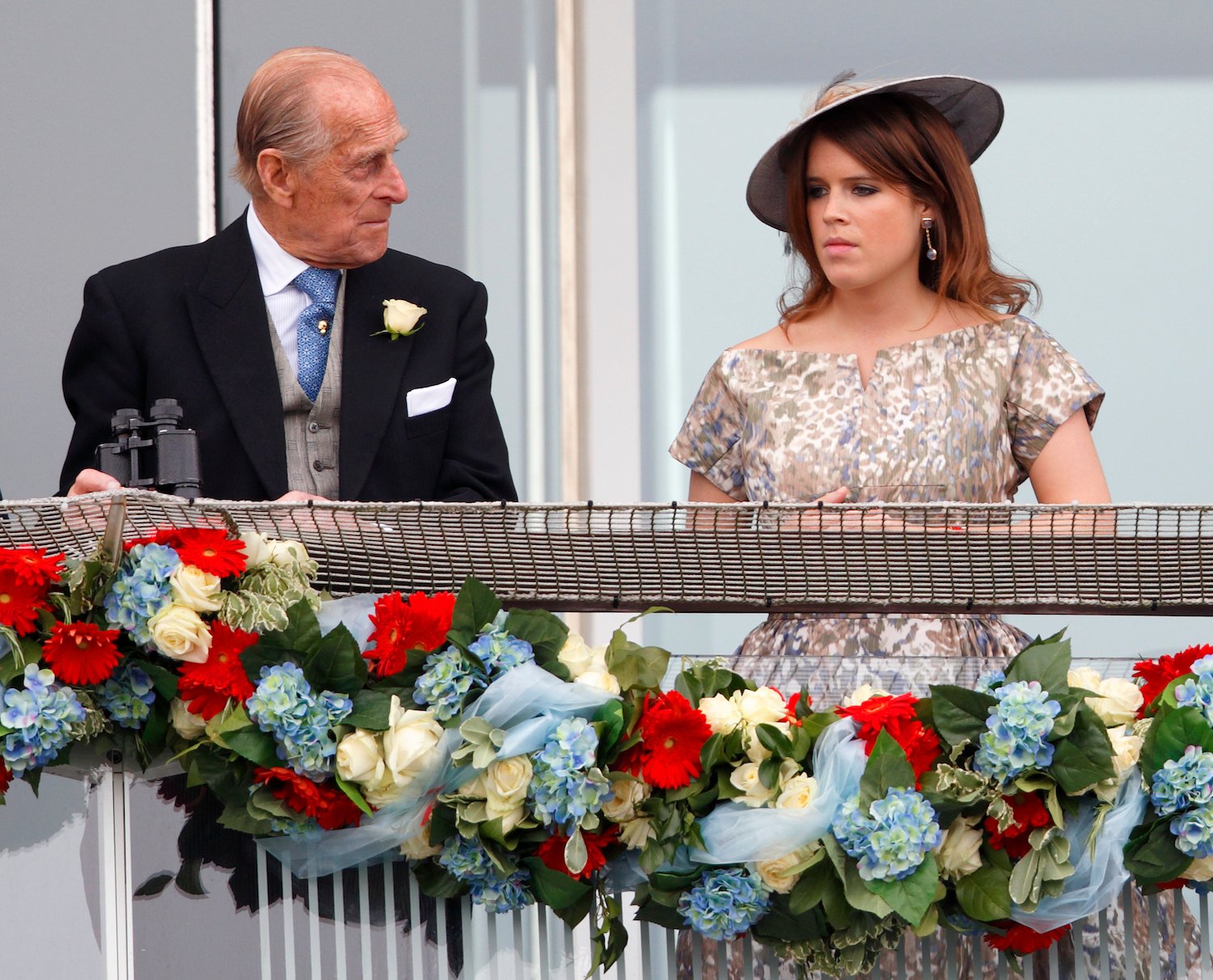 Prince Philip and Princess Eugenie stand at a balcony during Derby Day 2013