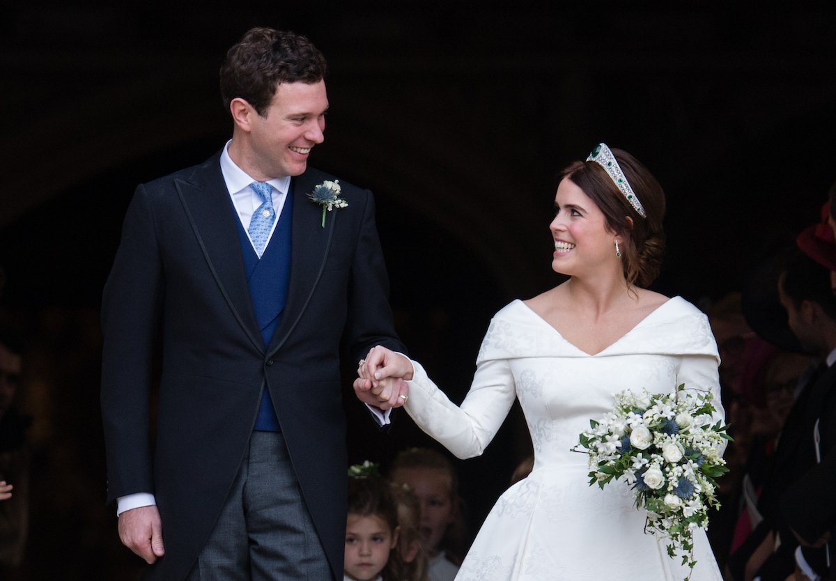 Princess Eugenie wedding photo of Jack Brooksbank (left) smiling at Princess Eugenie (right) as they leave the chapel