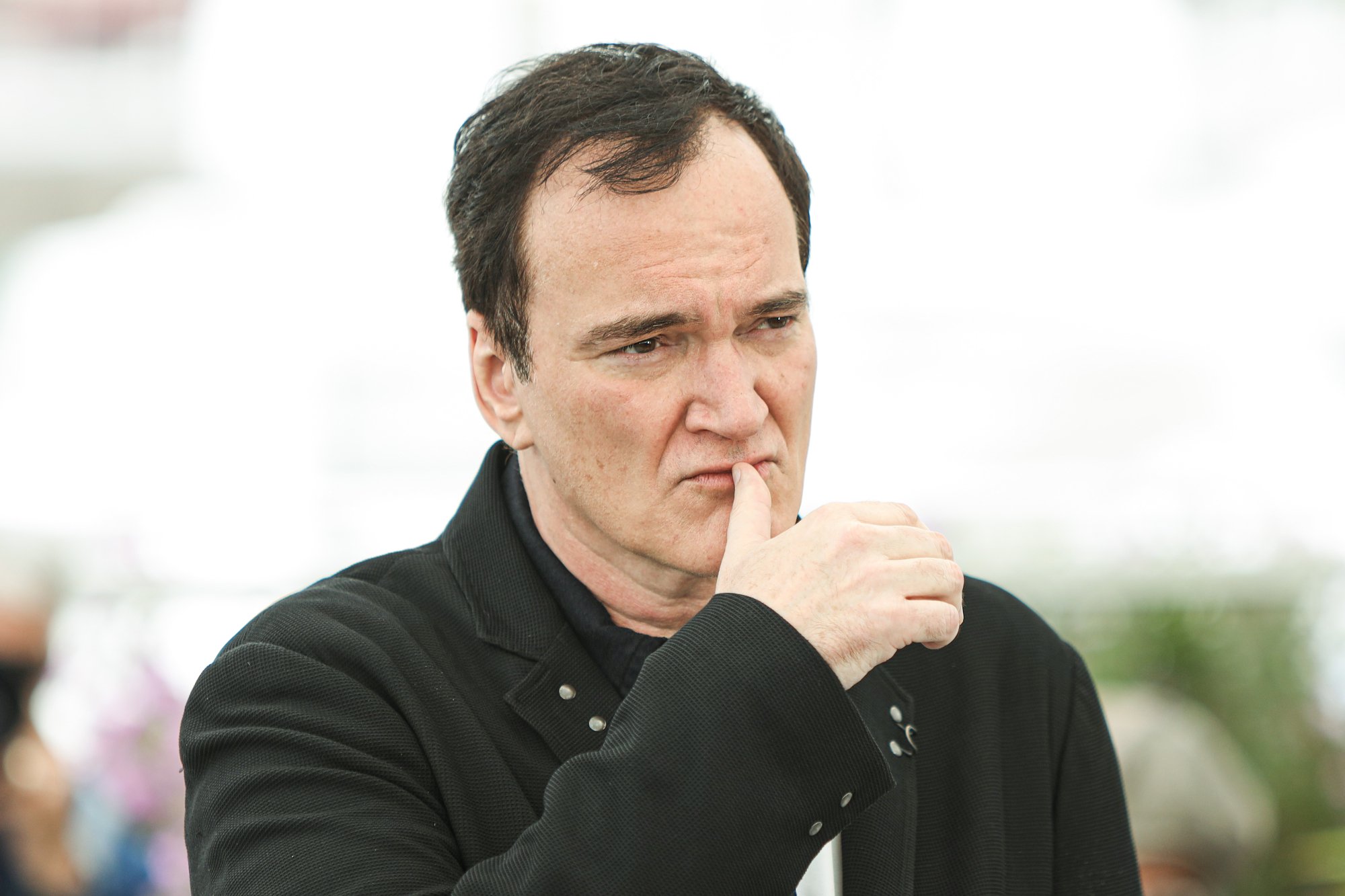 Quentin Tarantino with his thumb on his lips at the 72nd annual Cannes Film Festival for 'Once Upon a Time in Hollywood'