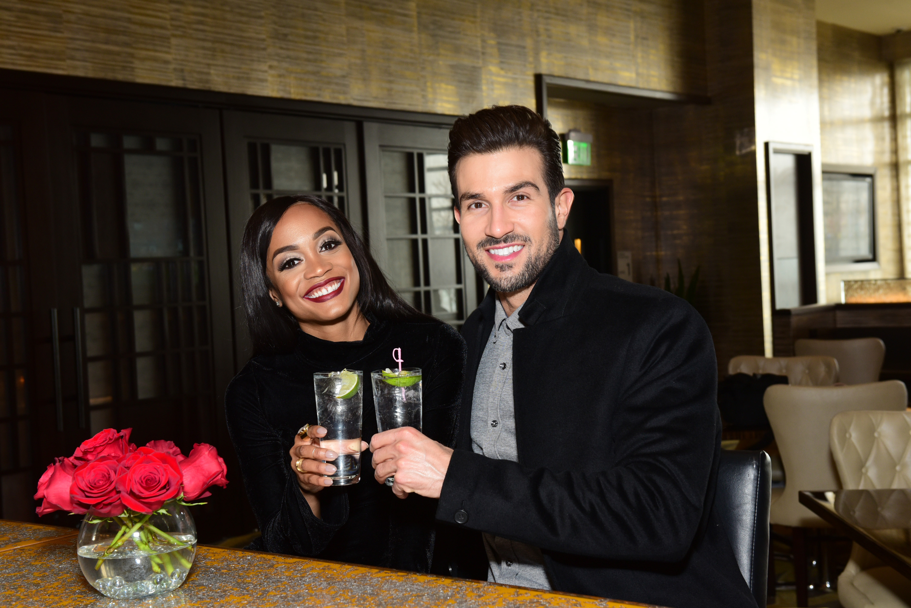 Rachel Lindsay clinks glasses with Bryan Abasolo.