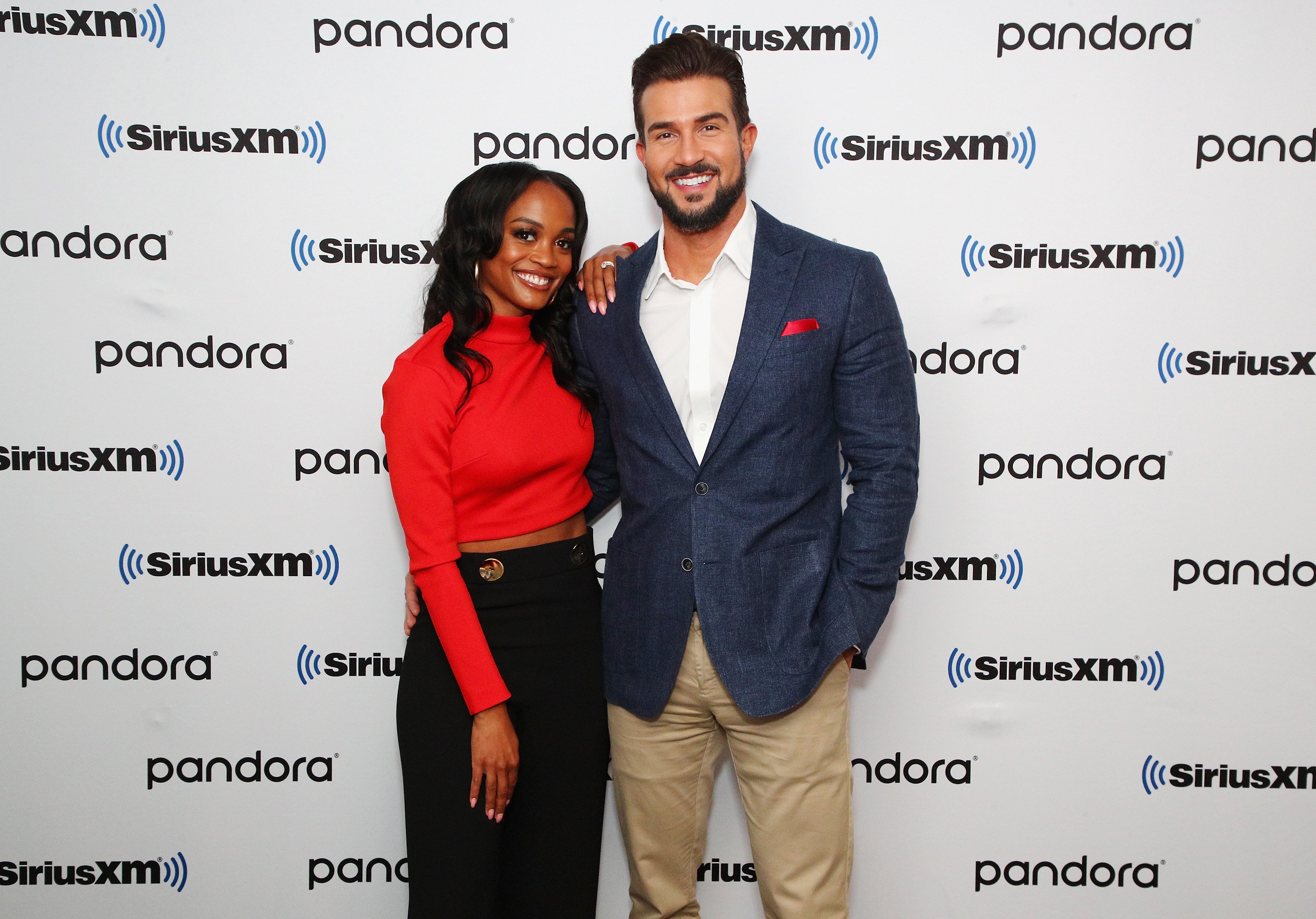 Rachel Lindsay in a red sweater and Bryan Abasolo in a blue suit.