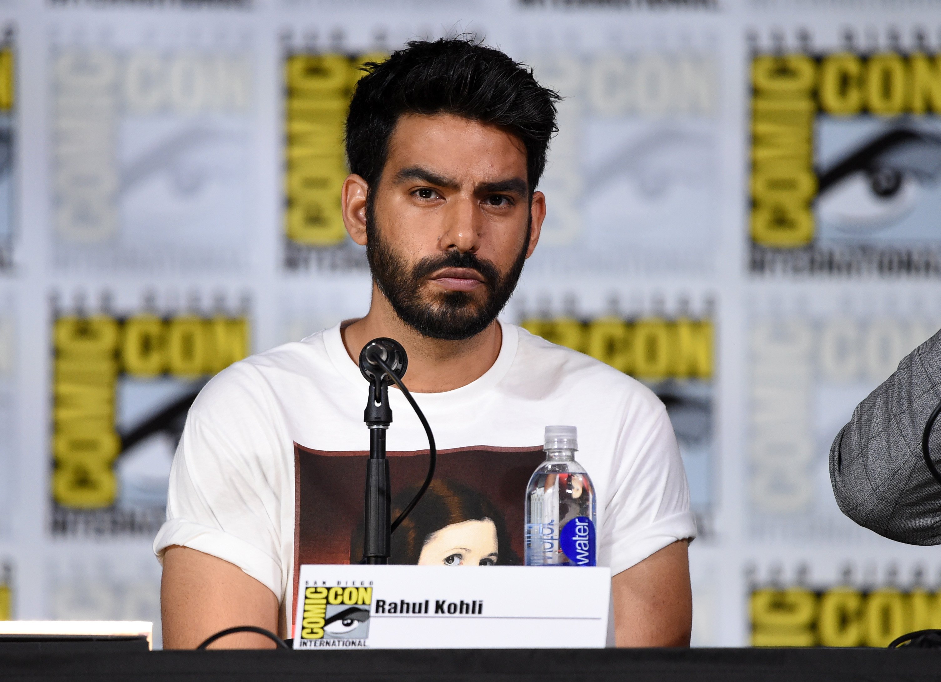 Midnight Mass actor Rahul Kohli in a white shirt at Comic Con.