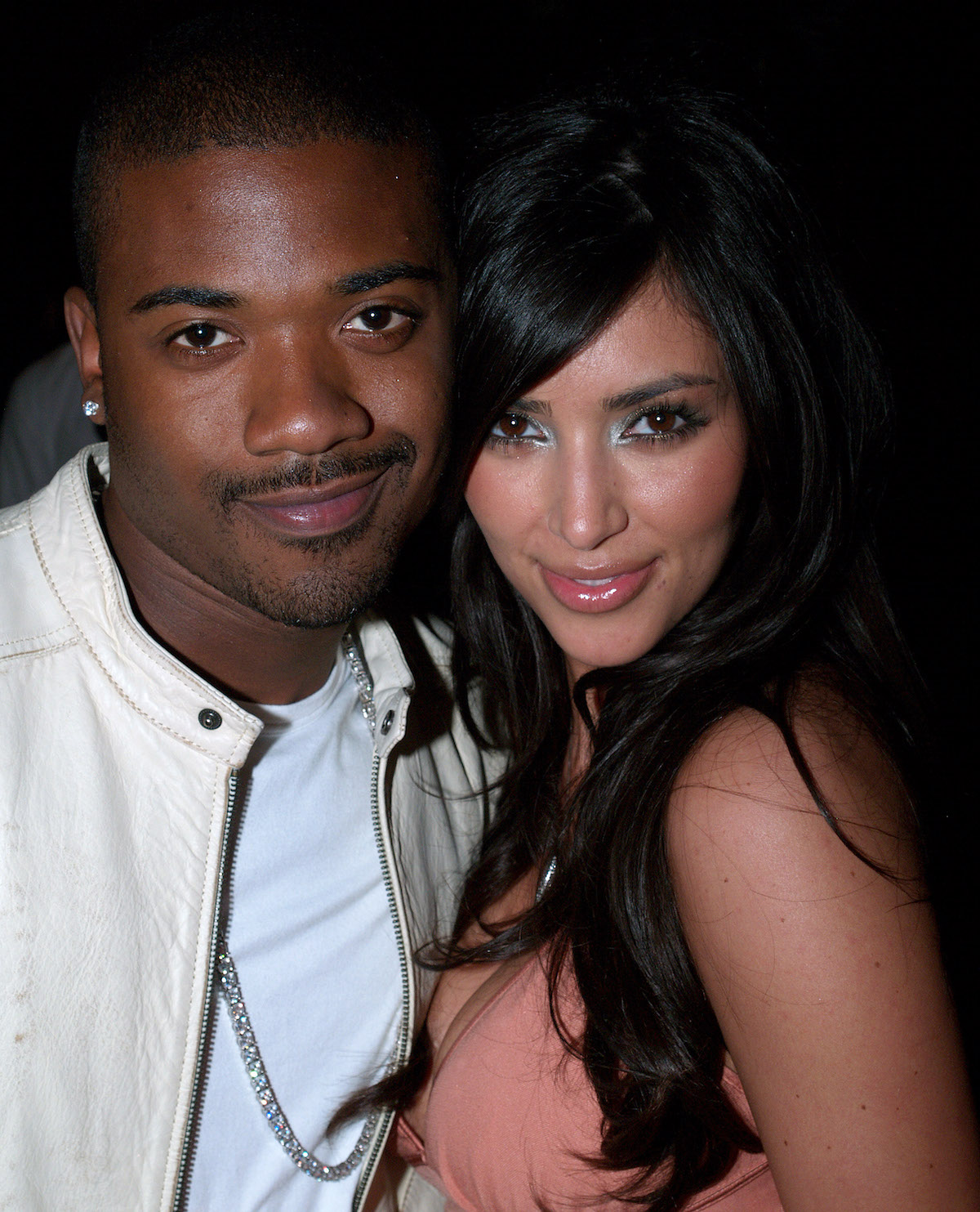 Ray J and Kim Kardashian pose together at an event.