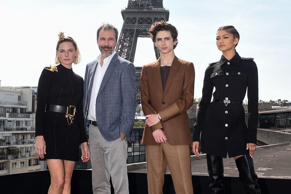 Rebecca Ferguson, Denis Villeneuve, Timothee Chalamet and Zendaya looking at the camera with the Eiffel Tower in the background. 