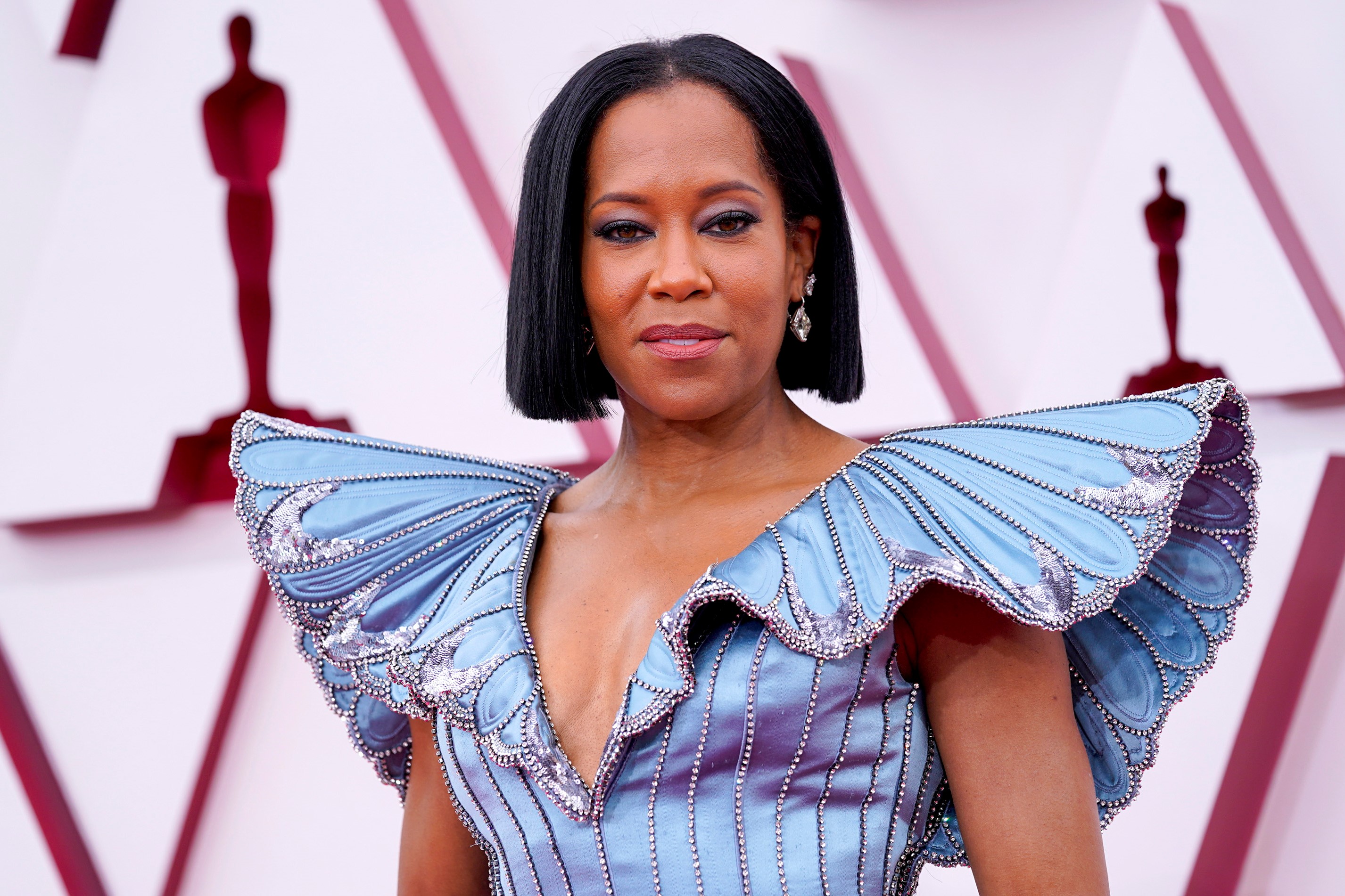 Regina King posing in a blue gown at Academy Awards in 2021.
