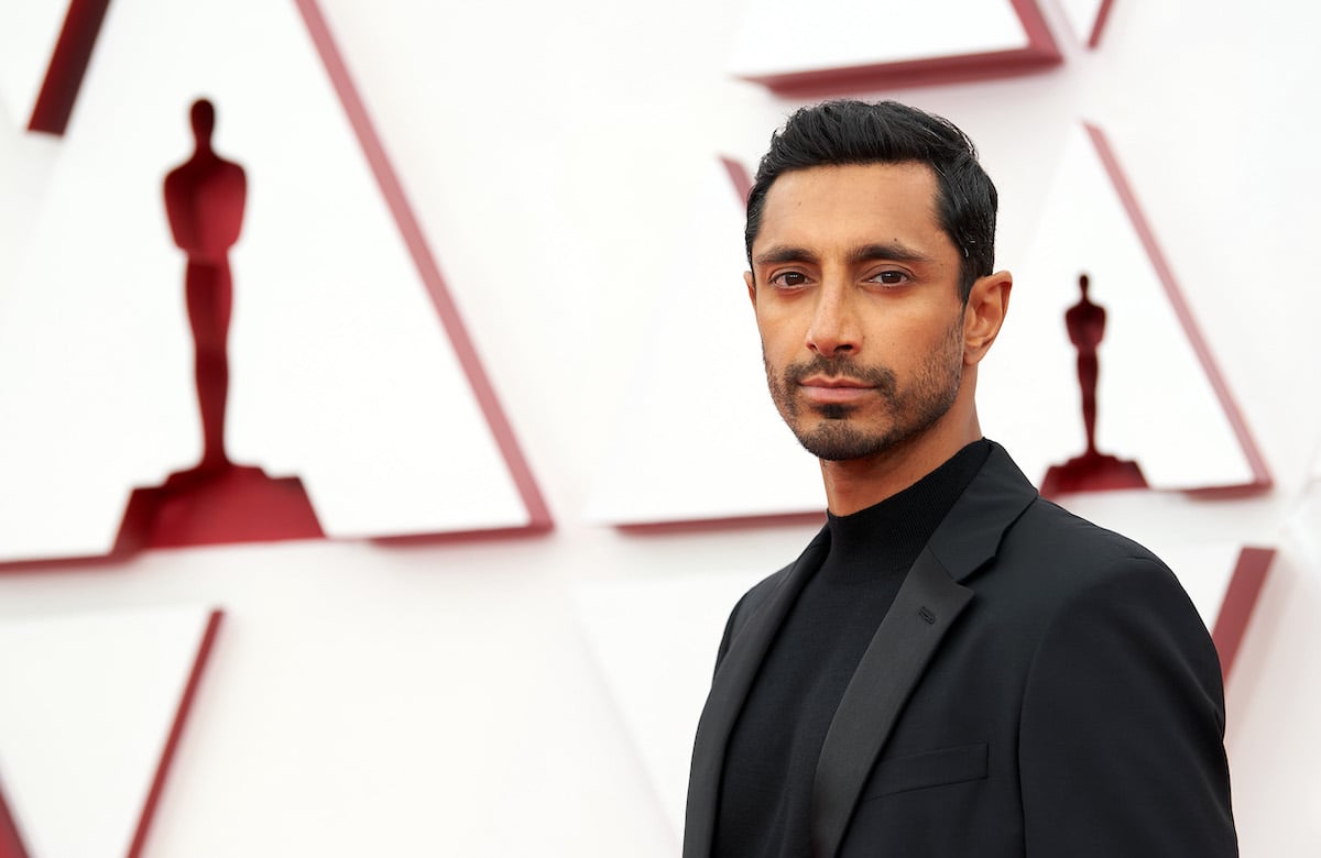 Riz Ahmed in a black suit on the red carpet