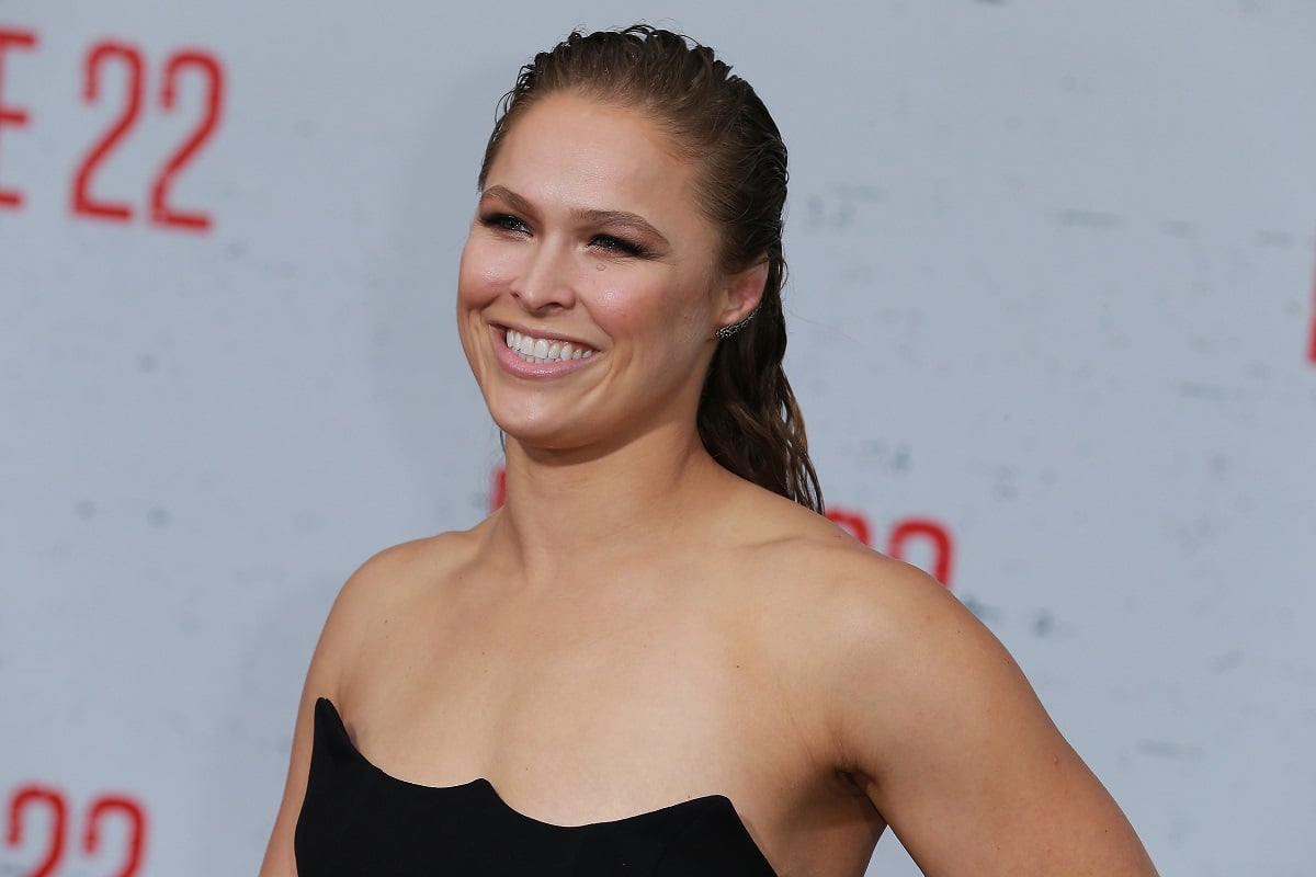 Ronda Rousey smiling in a black dress