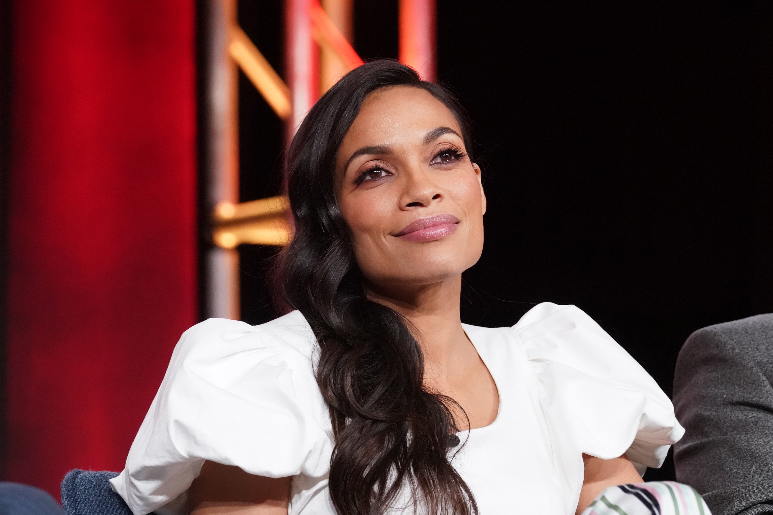 Rosario Dawson, in a white blouse, during the press tour for her show 'Briarpatch.'