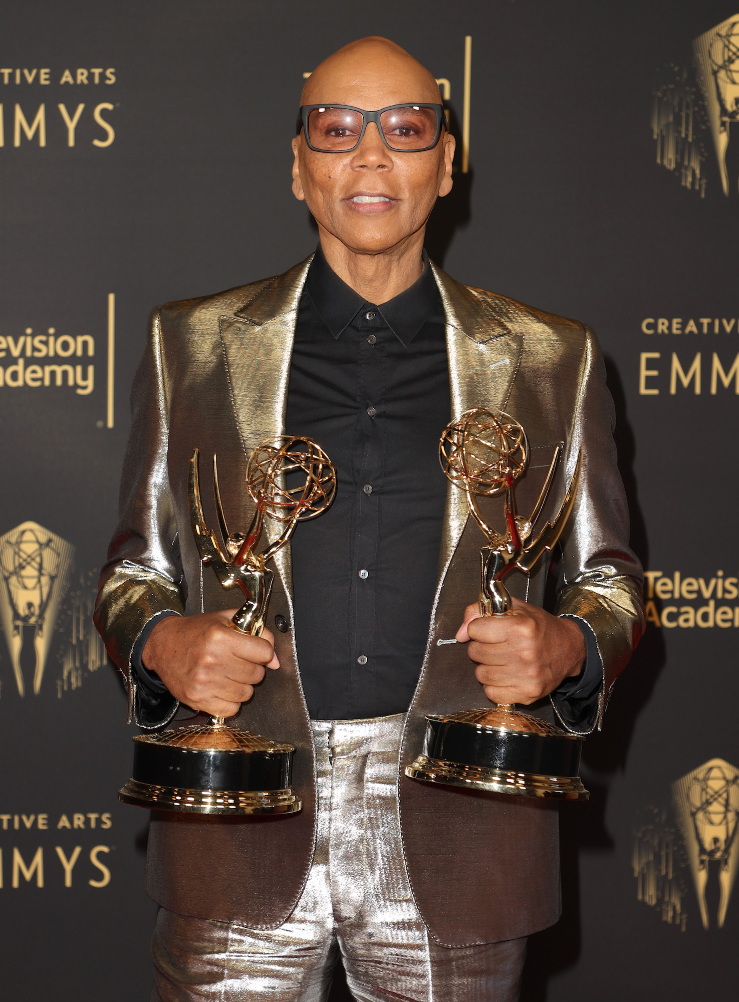 RuPaul holding two Emmy awards at the 2021 Creative Arts Emmys
