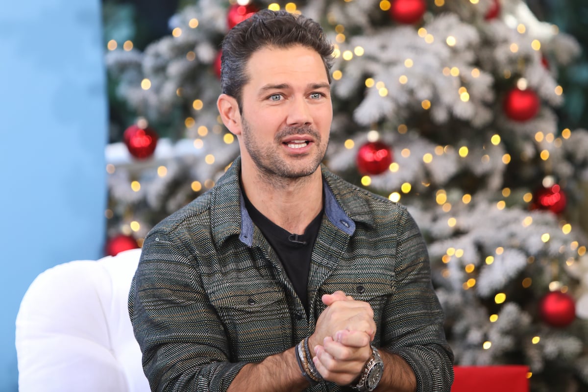 Ryan Paevey sits in front of a Christmas tree during an appearance on Hallmark Channel's 'Home & Family'