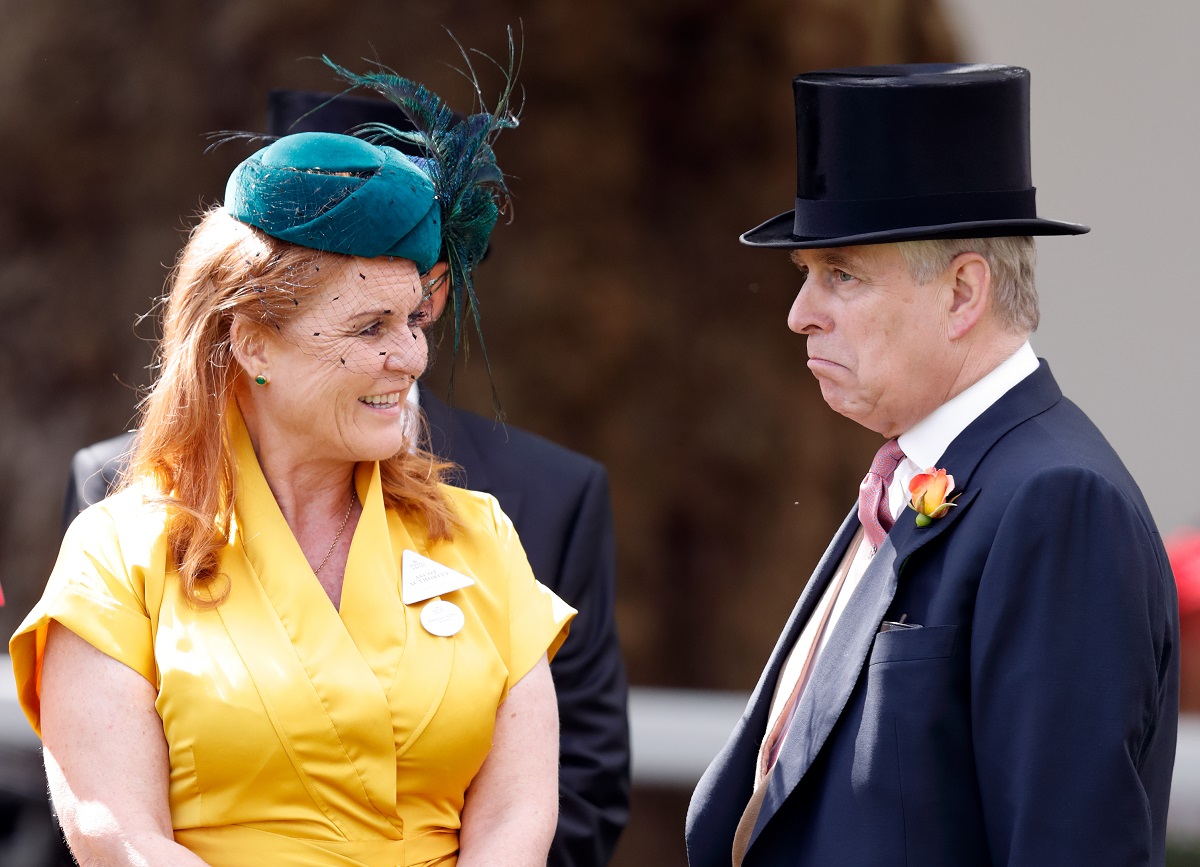 Sarah Ferguson wearing a yellow dress & fascinator, and Prince Andrew sporting a top hat as they talk amongst themselves at the Royal Ascot