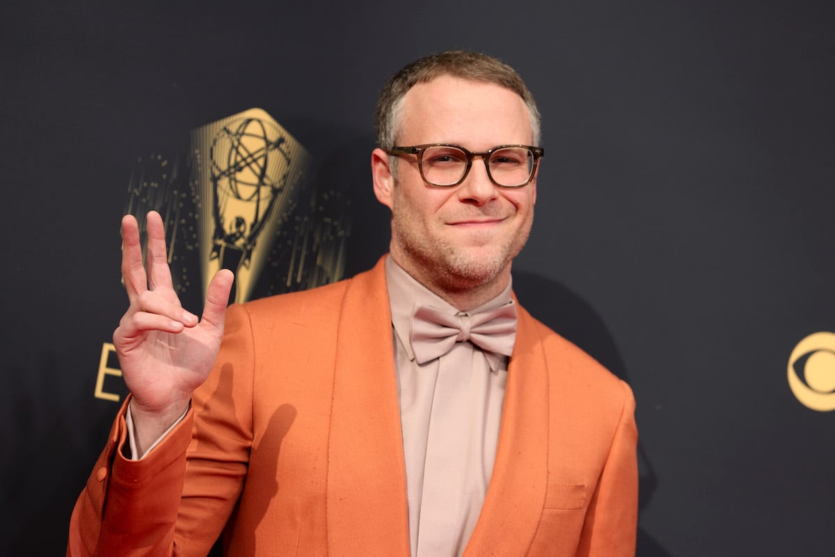 Seth Rogen flashes a peace sign and a smile at the camera.