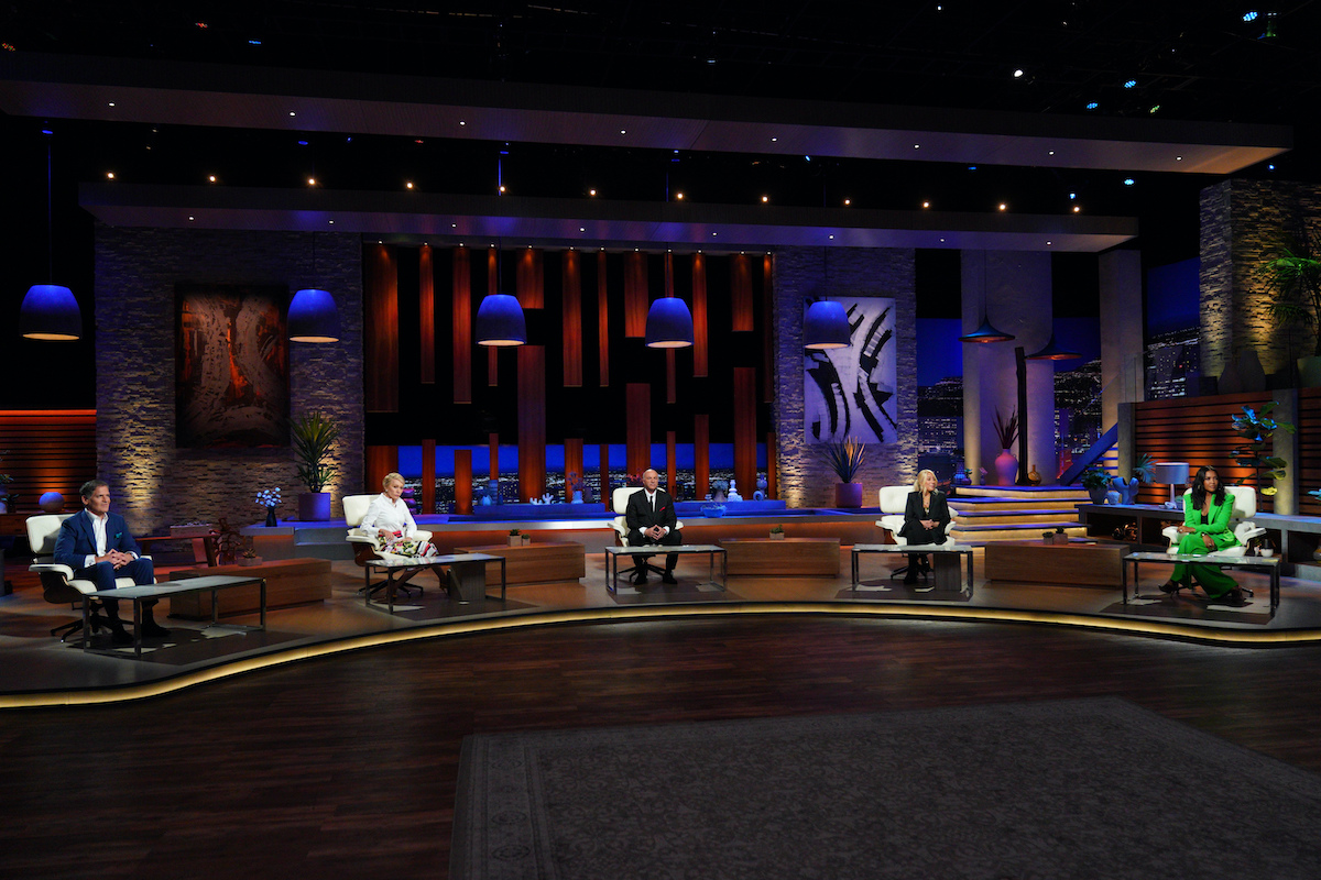 Shark Tank judges on a dimly lit set