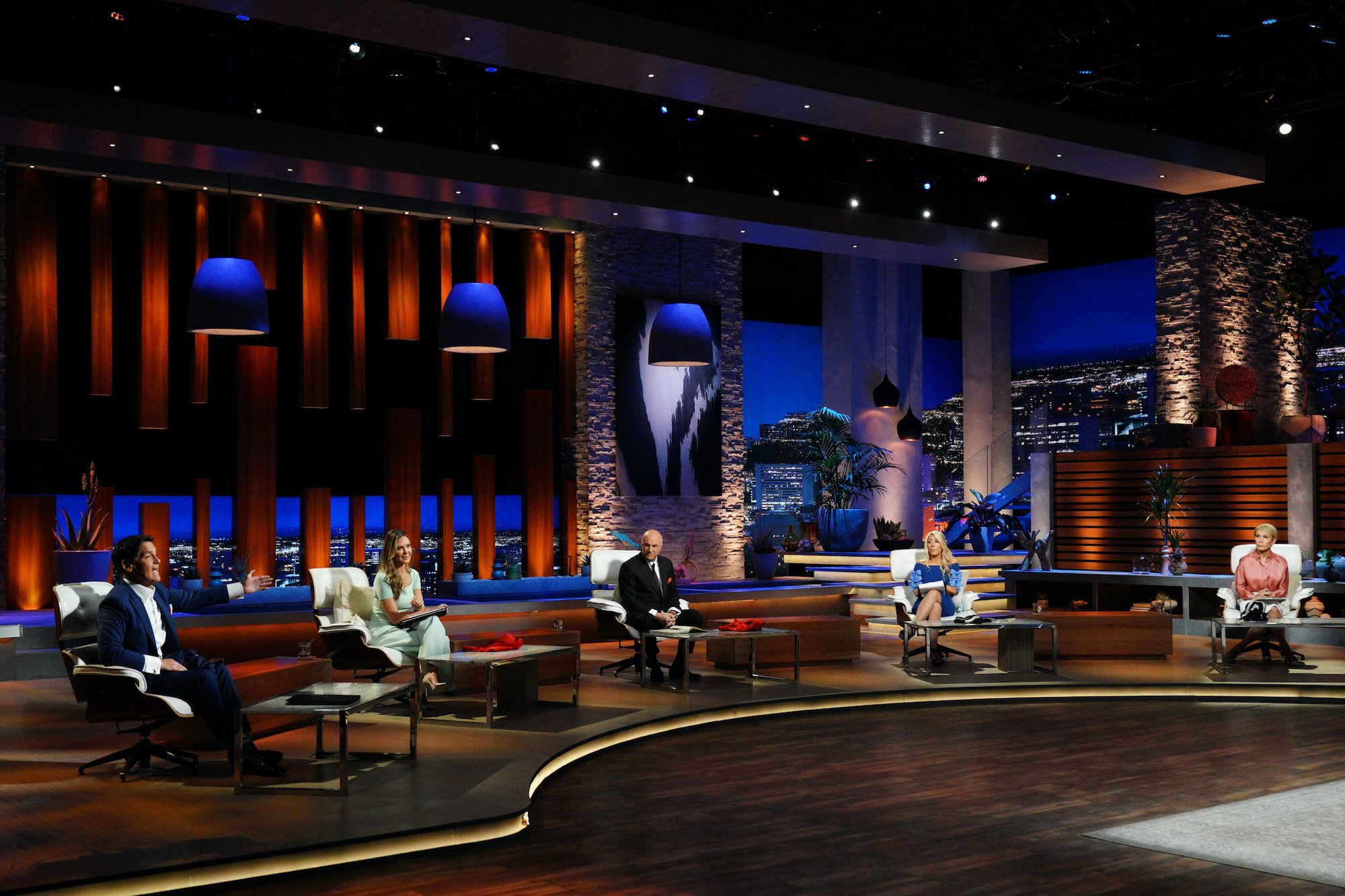 'Shark Tank' judges sitting distanced on a dais