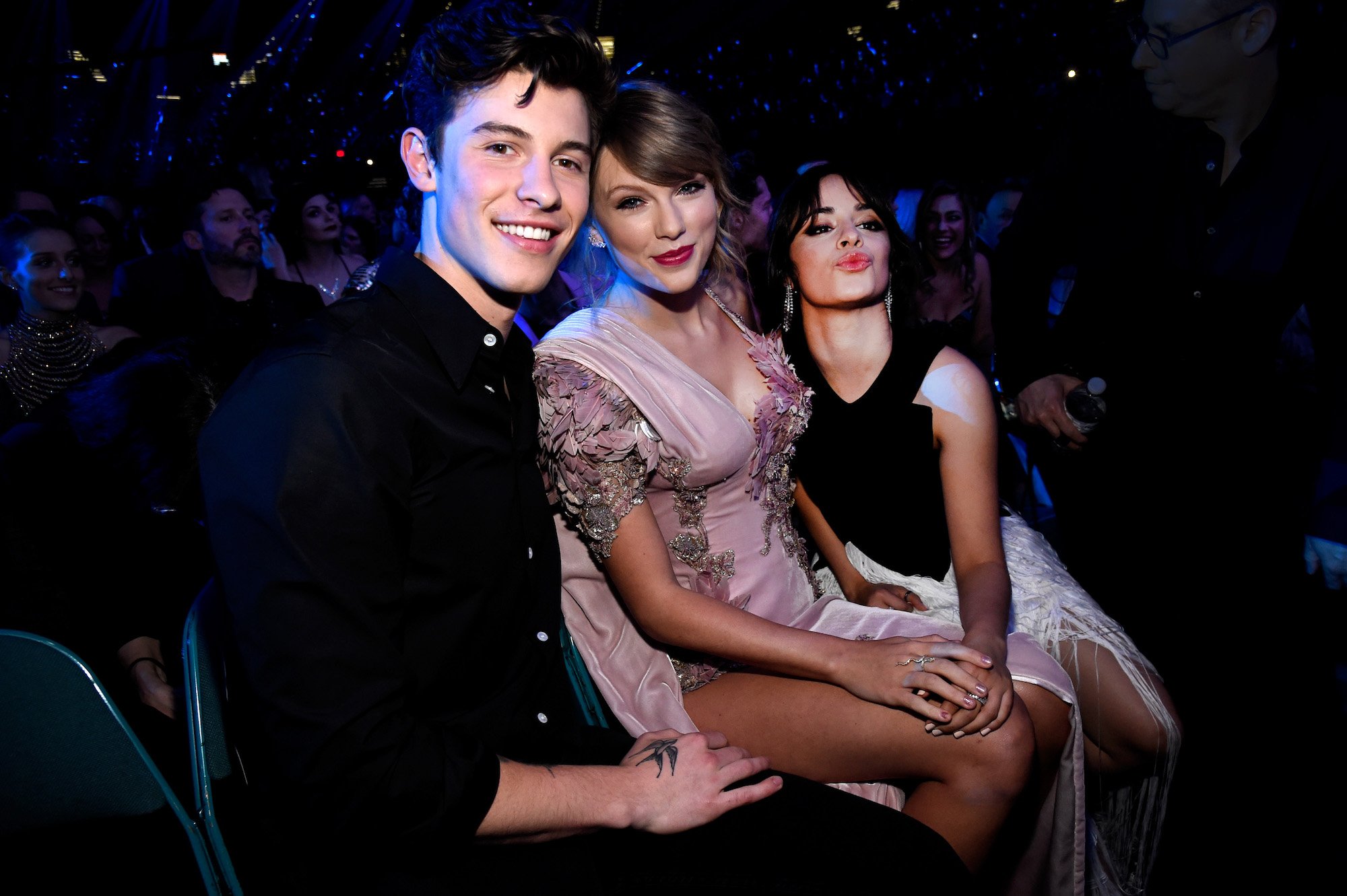 Shawn Mendes, Taylor Swift, and Camila Cabello posing for a photo at the 2018 Billboard Music Awards