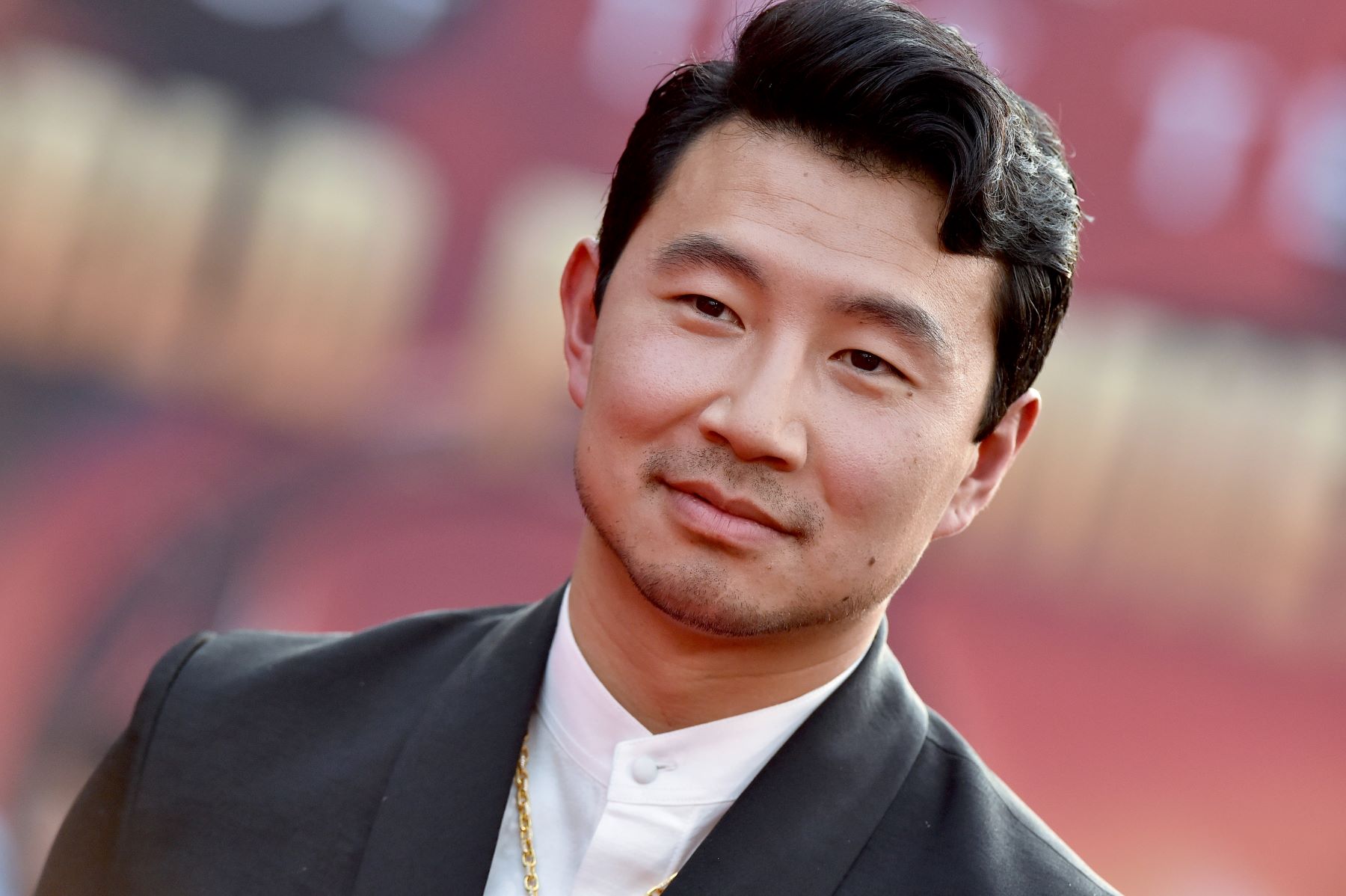 Simu Liu smiles for cameras at the premiere of 'Shang-Chi and the Legend of the Ten Rings.'