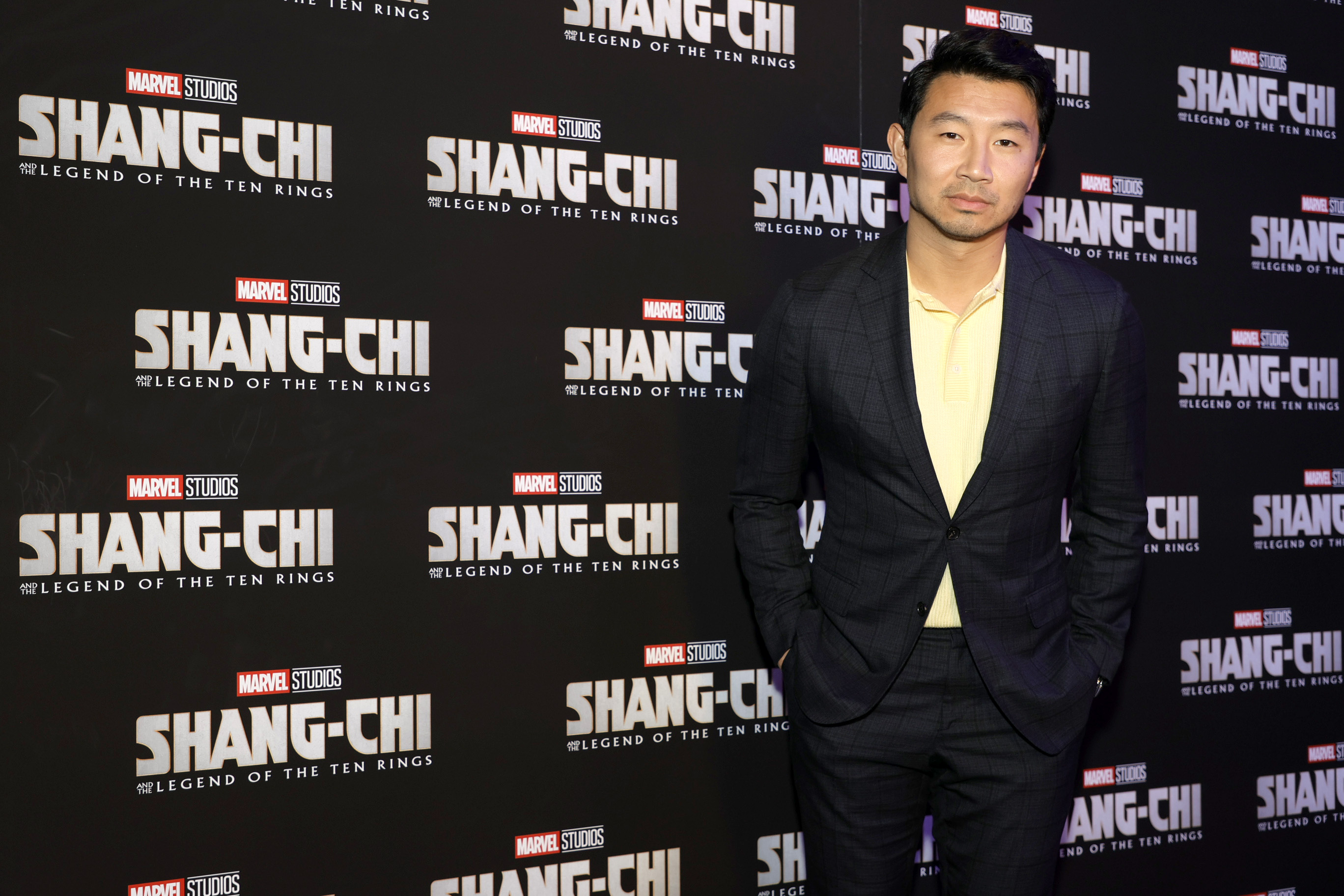 Simu Liu poses for pictures at a screening for 'Shang-Chi and the Legend of the Ten Rings.'
