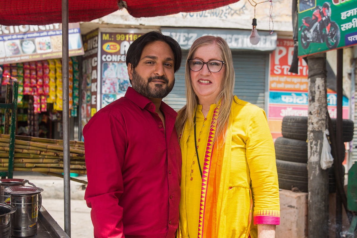 Sumit and Jenny pose together next to a sugarcane vendor on the streets of Greater Noida, as seen on '90 Day Fiancé: The Other Way'