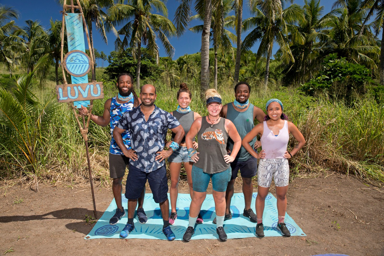 The Luvu Tribe standing together with their tribe sign from 'Survivor' Season 41. 'Survivor' Season 41 spoilers note Luvu won the first immunity challenge