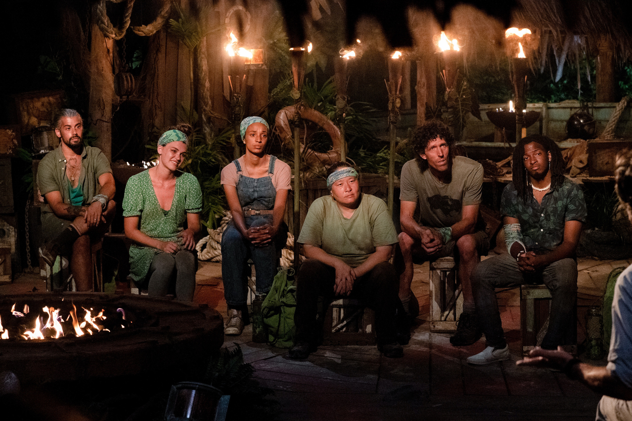 'Survivor' Season 41 tribe at Tribal Council at night surrounded by torches