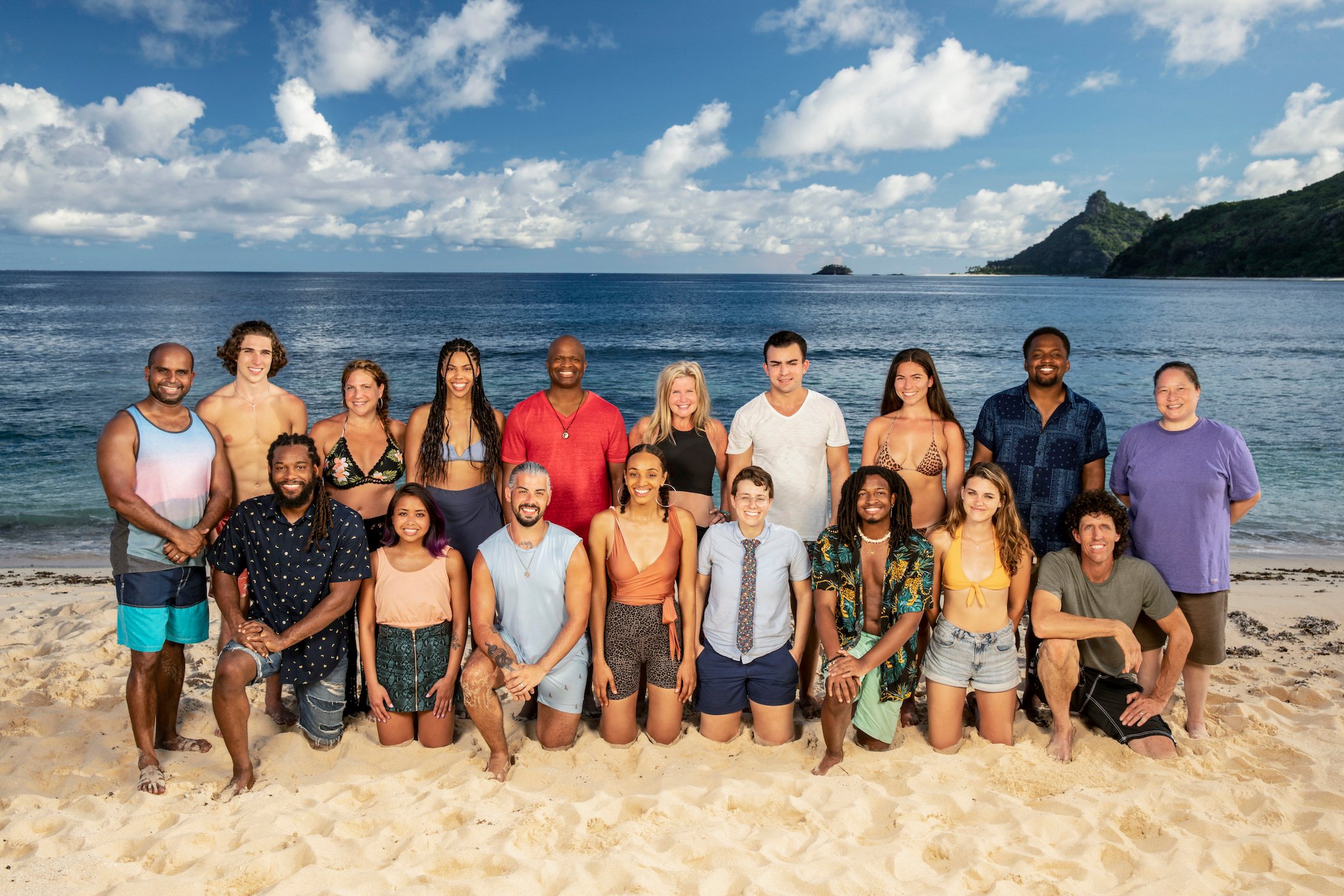 'Survivor' Season 41 cast kneeling on the beach and smiling at the camera