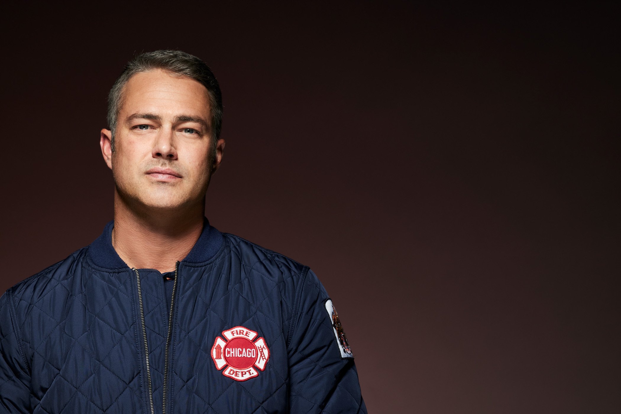 Taylor Kinney as Kelly Severide in 'Chicago Fire' Season 10 against a dark background