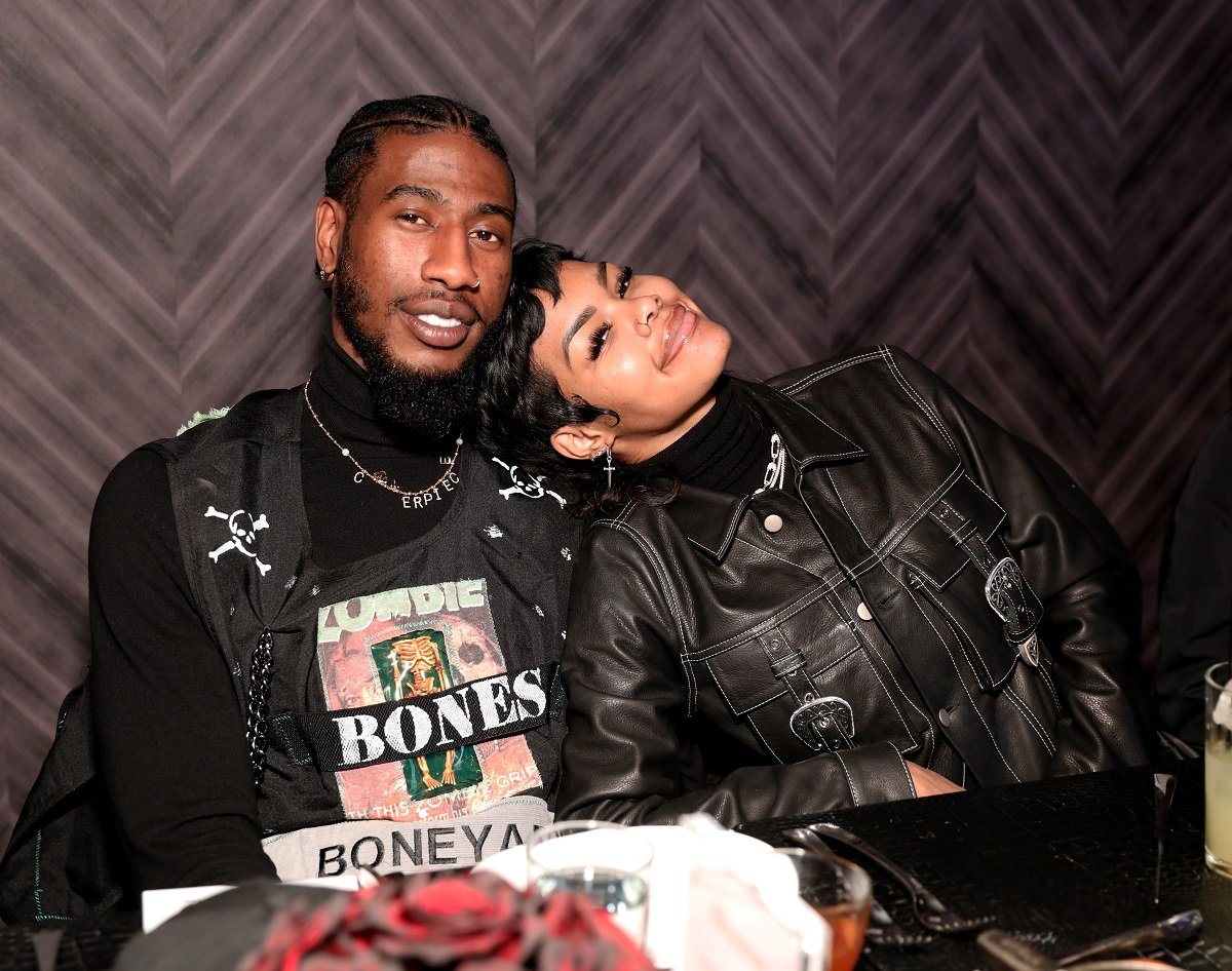 Teyana Taylor laying her head on Iman Shumpert's shoulder as they pose for a photo during an NBA All-Star Dinner
