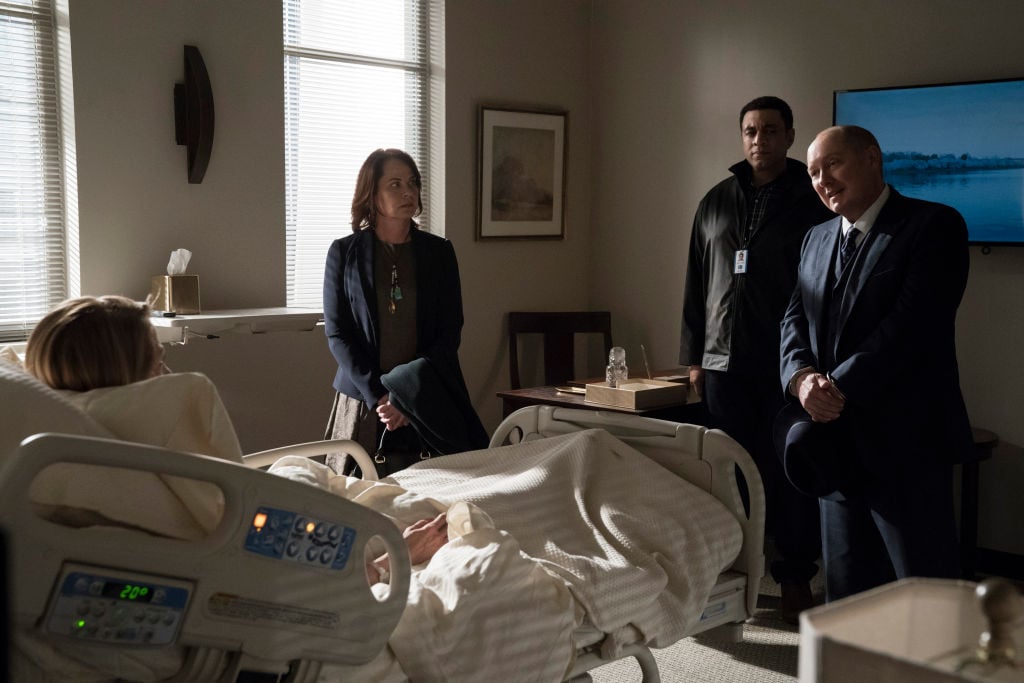 'The Blacklist' Regina Schneider as First Lady Miriam Diaz, Deirdre Lovejoy as Cynthia Panabaker, Harry Lennix as Harold Cooper, and James Spader as Raymond 'Red' Reddington all stand in a hospital room.