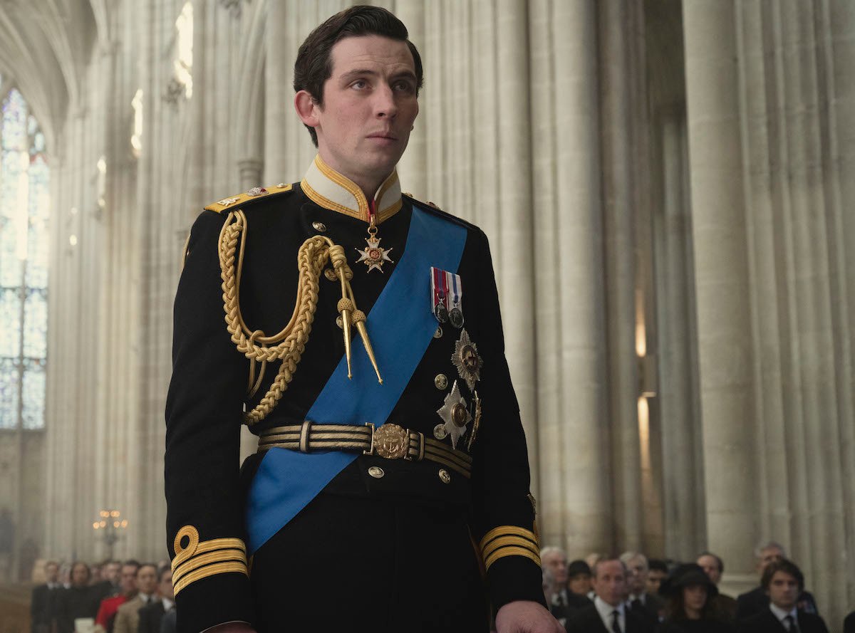 Prince Charles (JOSH O CONNOR) is standing in Winchester Cathedral