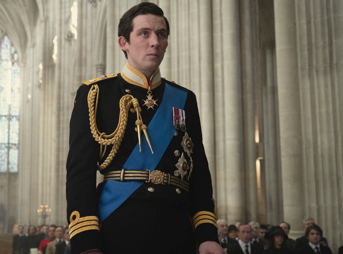 Prince Charles (JOSH O CONNOR) is standing in Winchester Cathedral 