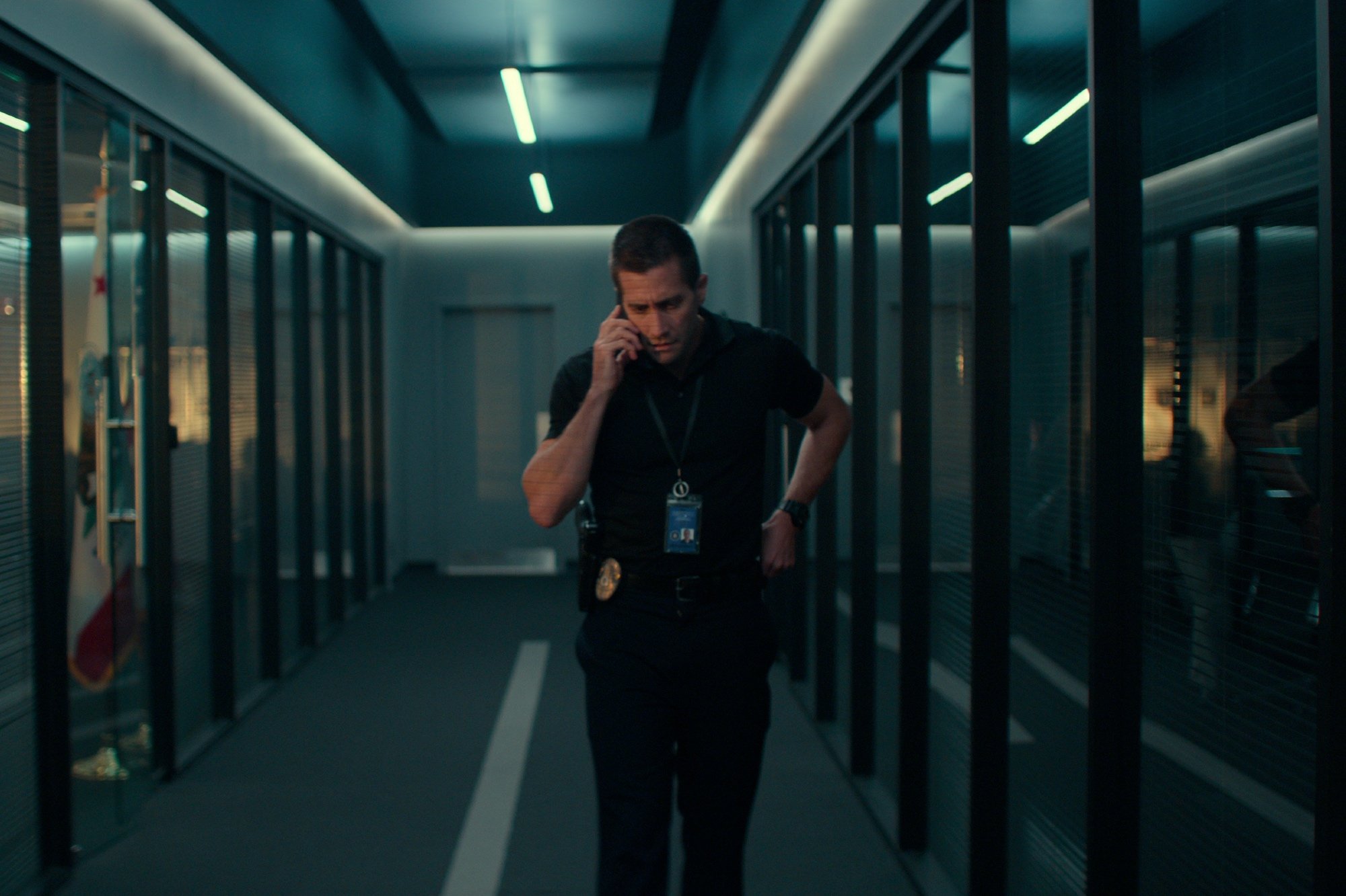 'The Guilty' actor Jake Gyllenhaal as Joe Bayler in the hallway on his phone
