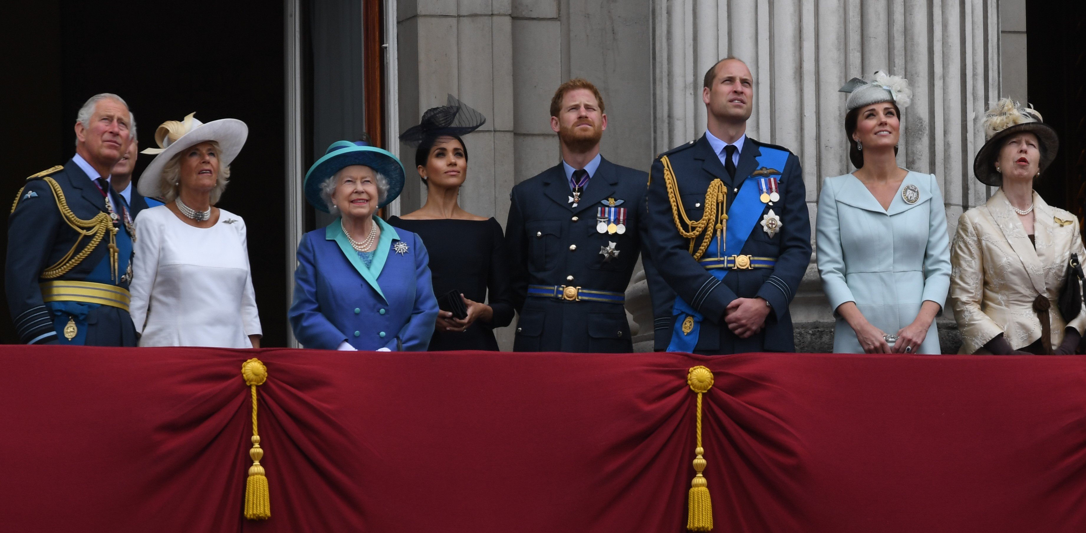 The Royal Family standing on the Buckingham Palace balcony watching a flypast
