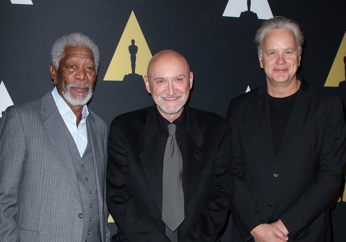 Morgan Freeman, Frank Darabont, and Tim Robbins smile for the camera. 
