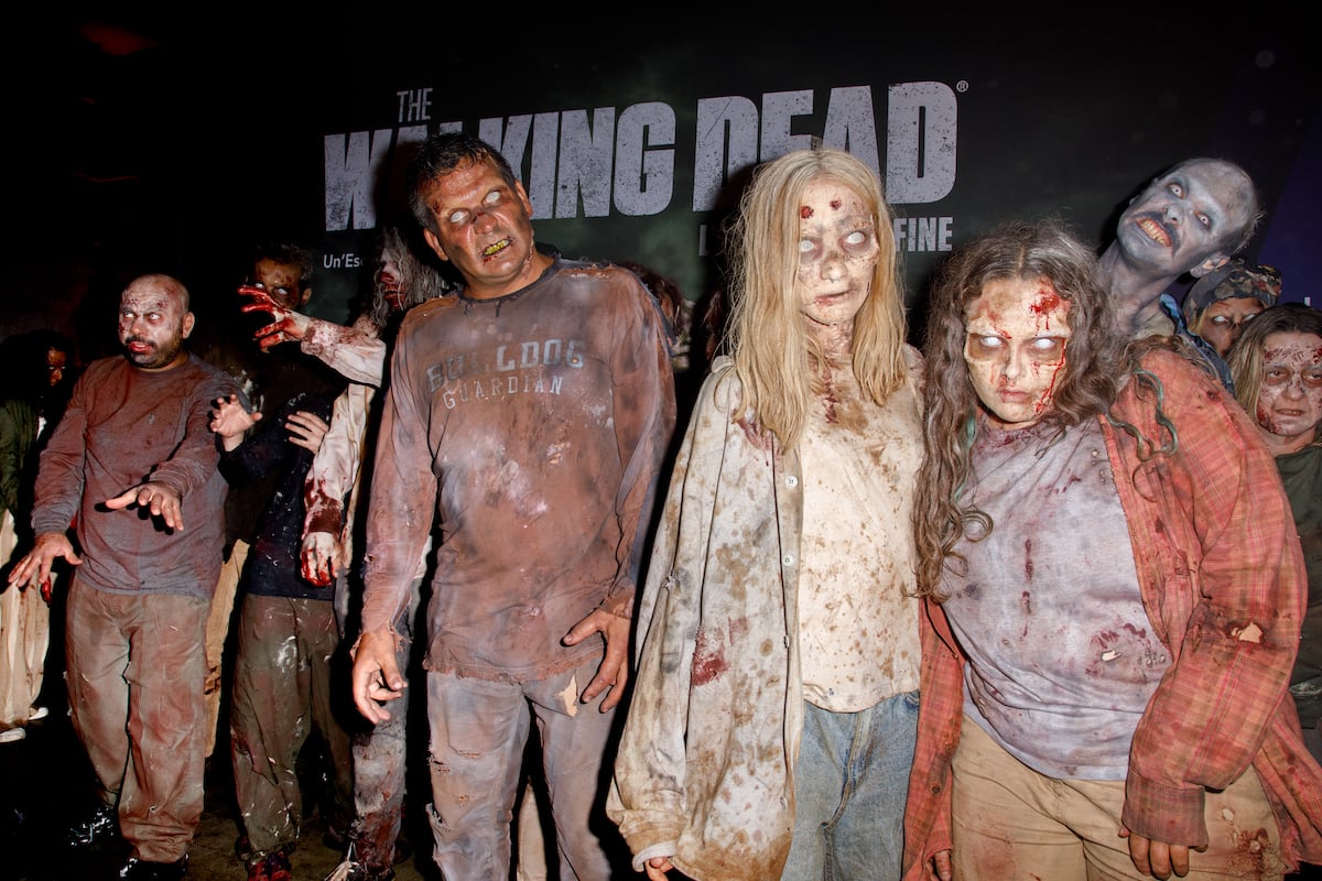 Zombies in front of a 'Walking Dead' backdrop