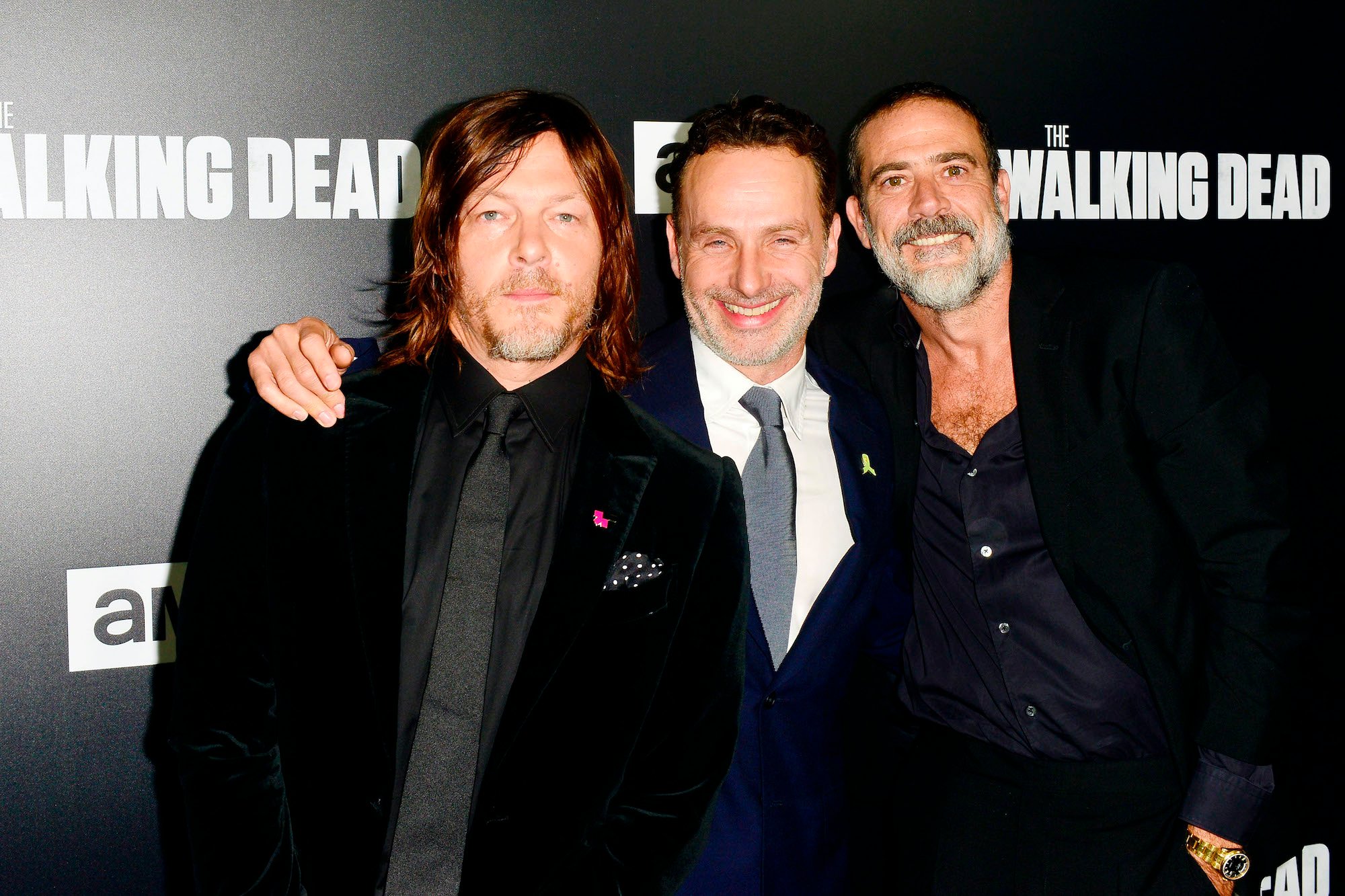 Cast members from 'The Walking Dead' in front of a black background