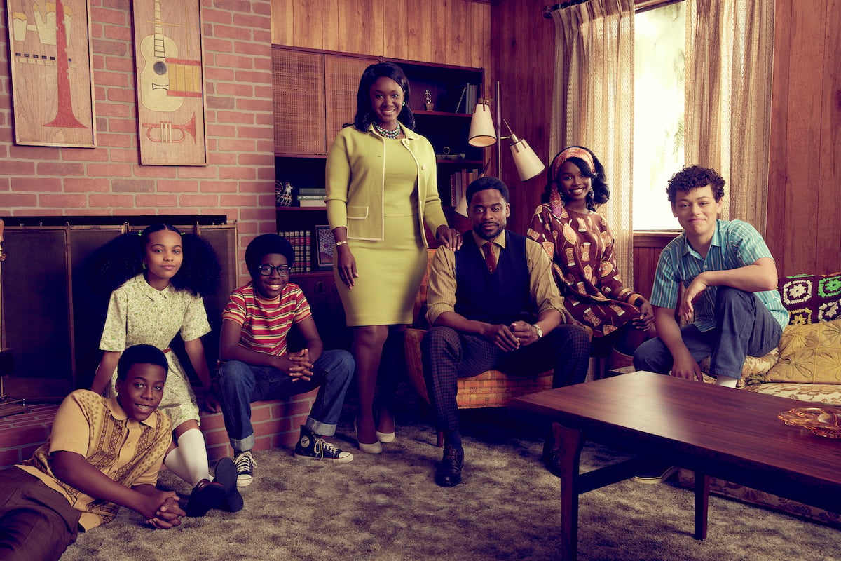 Amari ONeil as Cory Long, Milan Ray as Keisa Clemmons, Elisha Williams as Dean Williams, Saycon Sengbloh as Lillian Williams, Dulé Hill as Bill Williams, Laura Kariuki as Kim Williams, and Julian Lerner as Brad Harper smiling for the camera in the living room in 'The Wonder Years