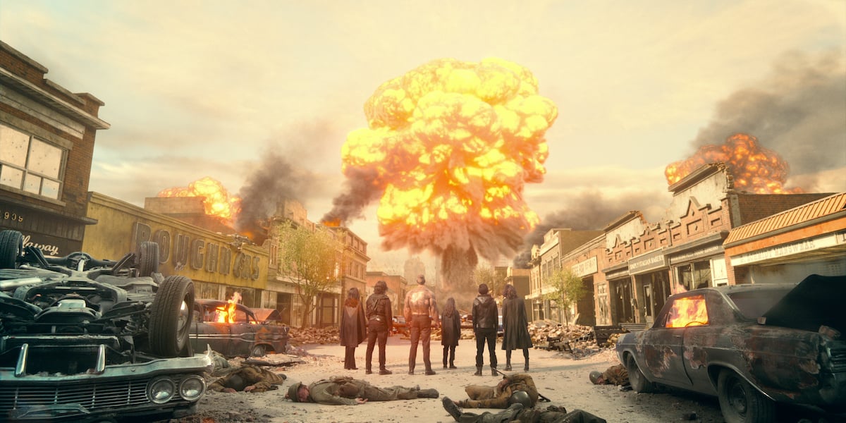 An explosion happens in the distance as the Hargreeves siblings look on in a scene from 'The Umbrella Academy' Season 2.