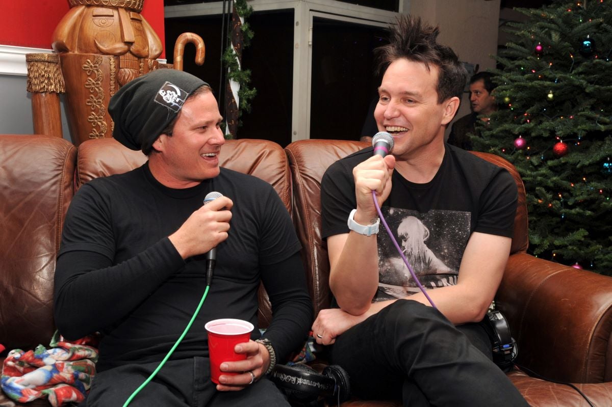 Tom DeLonge and Mark Hoppus chat with microphones