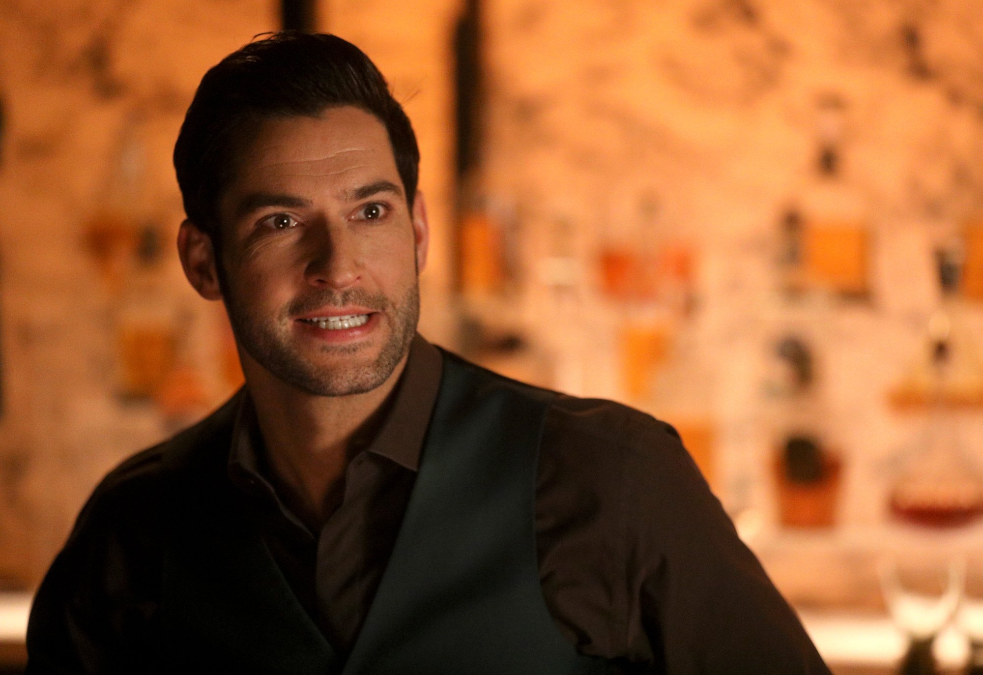 Tom Ellis as Lucifer Morningstar in 'Lucifer.' He's wearing a suit and looks concerned or confused.