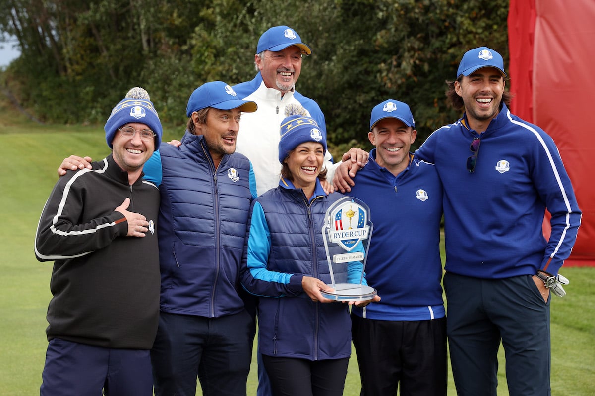 Tom Felton, Teemu Selanne, Toni Kukoc, Stephanie Szostak, Alessandro Del Piero, and Sasha Vujacic pose for photos with the trophy after winning the celebrity matches ahead of the 43rd Ryder Cup.