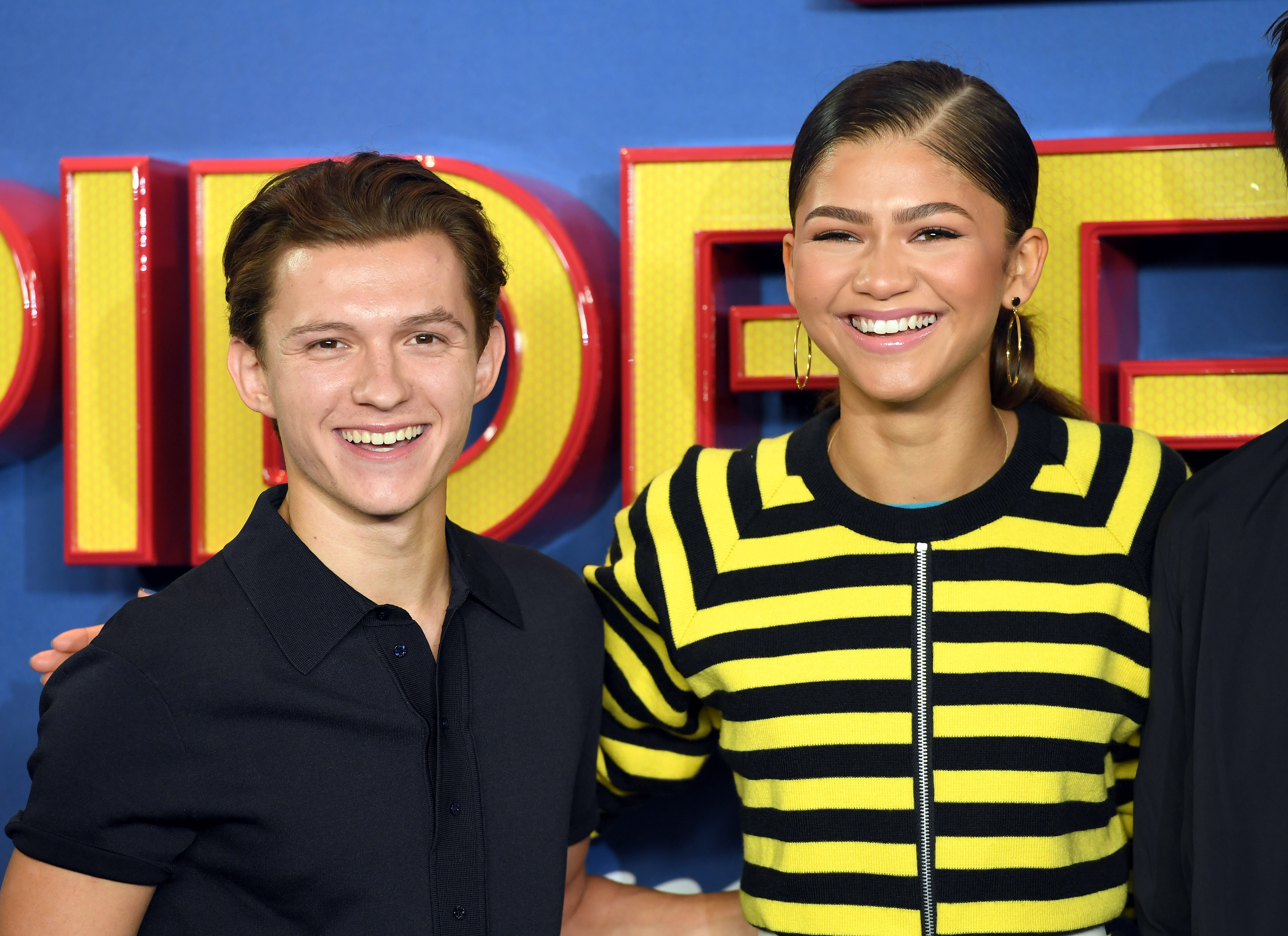 Tom Holland and Zendaya smiling at Spider-Man premiere