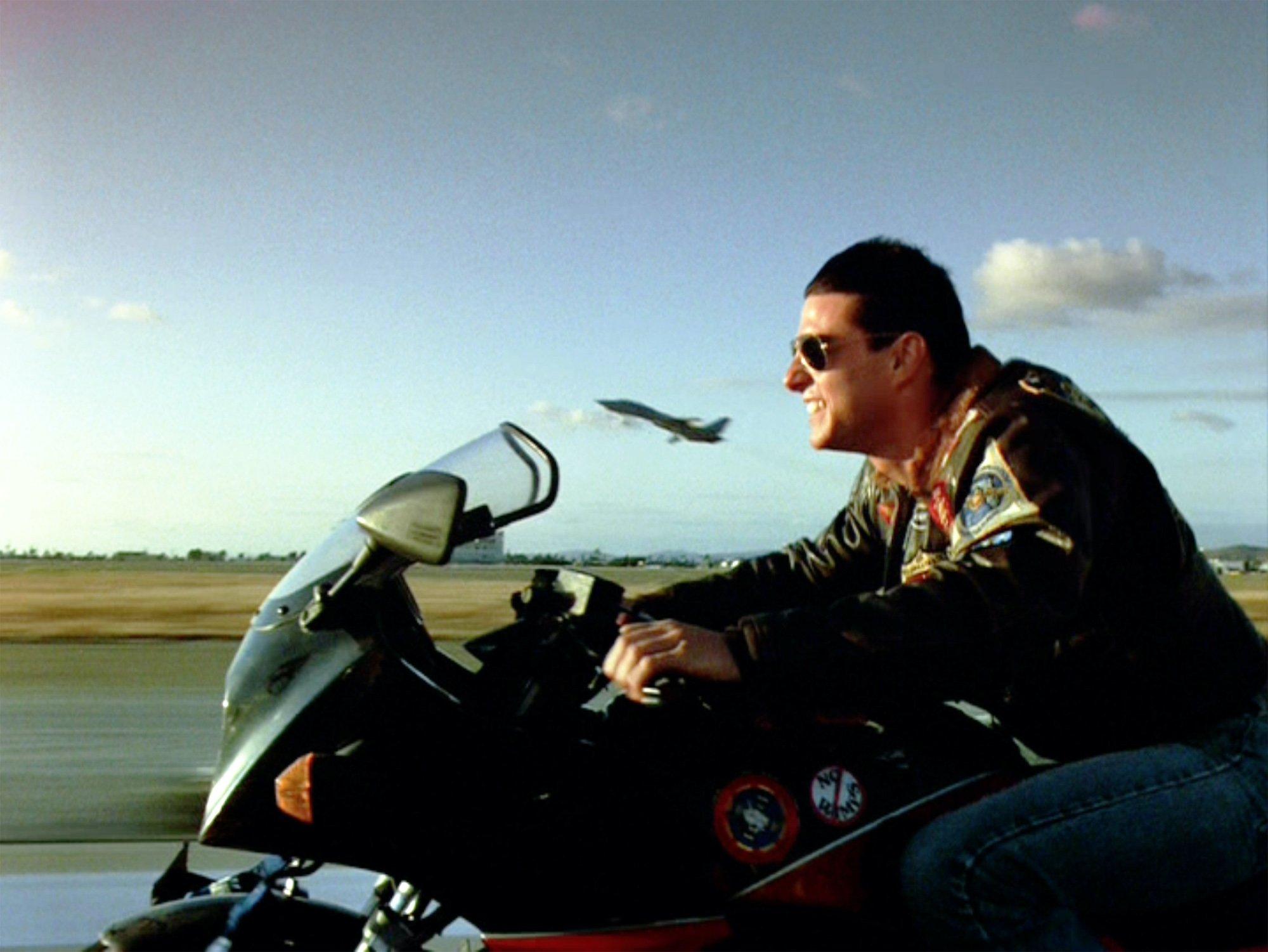 Tom Cruise as Lt. Pete 'Maverick' Mitchell on a motorcycle