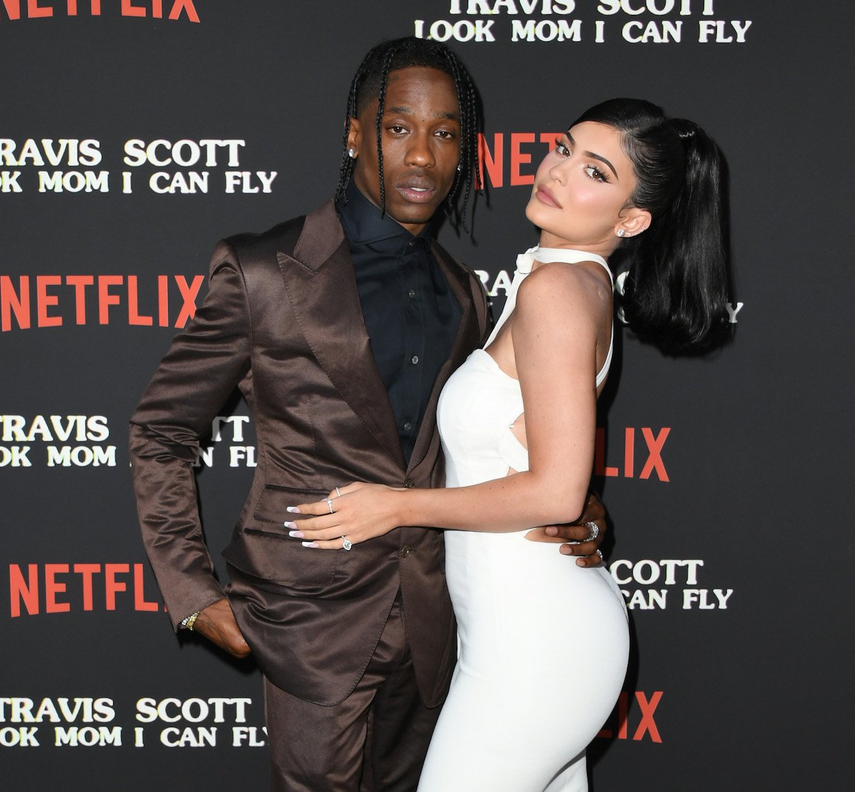 Travis Scott and Kylie Jenner pose together at an event.