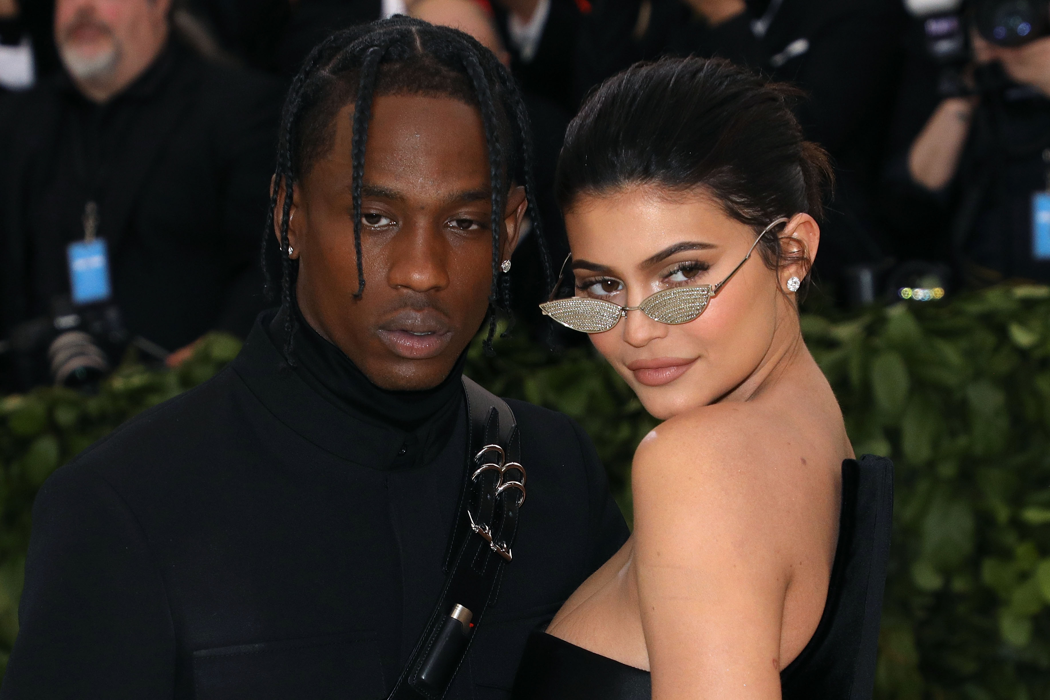 Travis Barker and Kylie Jenner wearing black couture outfits at the Met Gala.