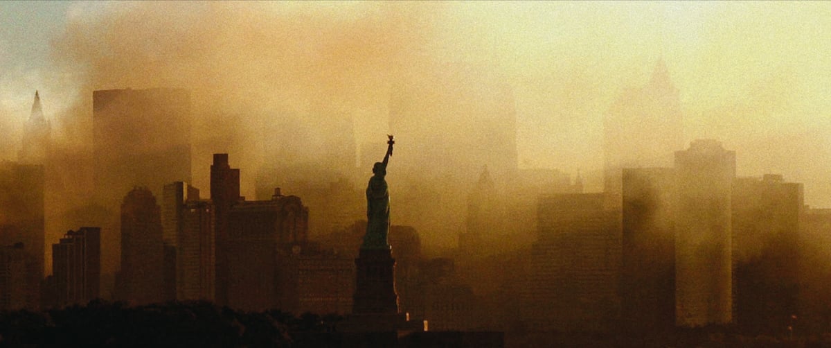 Statue of Liberty in front of New York City skyline, surrounded by smoke