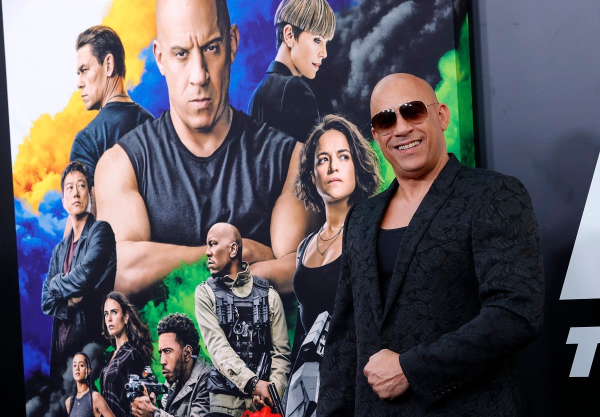Vin Diesel wears sunglasses and smiles for the camera.