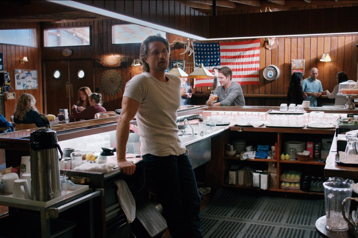 Martin Henderson as Jack Sheridan leaning against a bar in 'Virgin River'